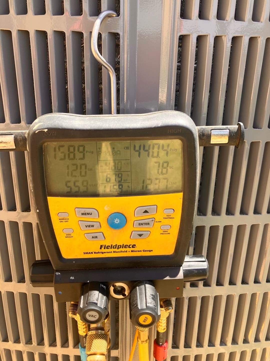 Digital manifold connected at the outdoor unit shows operating pressures of 159 PSI suction and 440 PSI liquid with 7.8 subcooling.