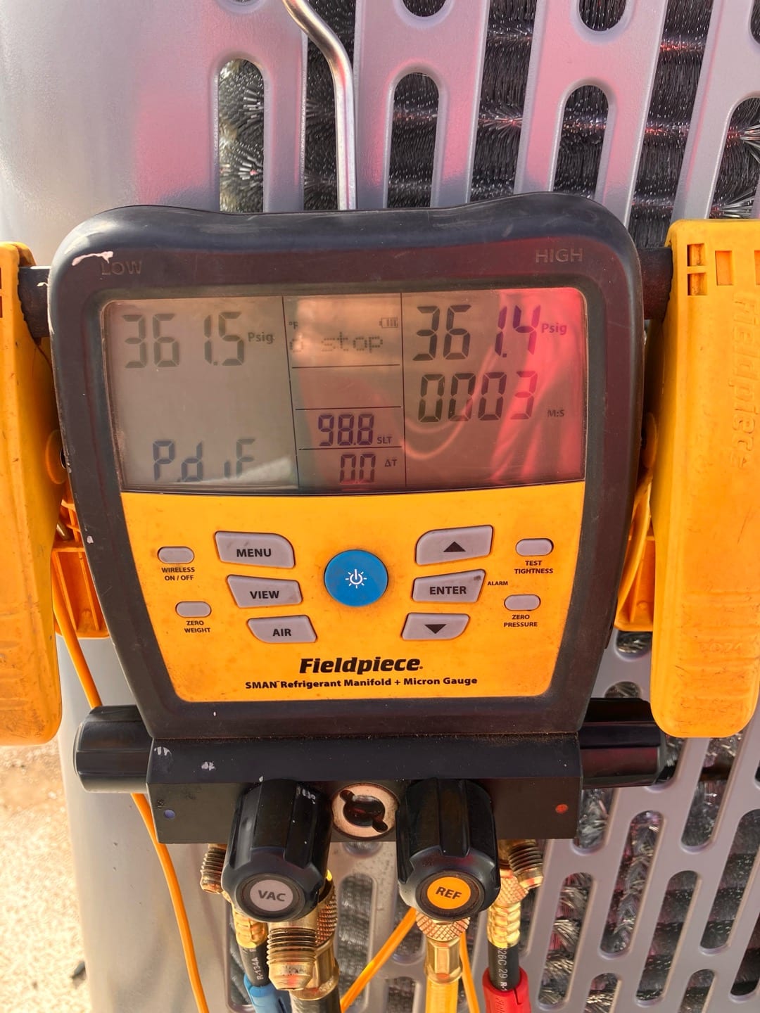 Digital manifold shows equal pressures around 361 PSI on both sides during a nitrogen pressure test at the outdoor unit.