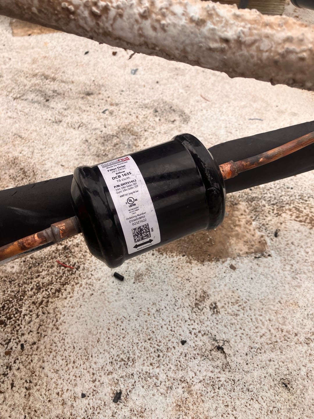 Liquid line filter drier brazed into the copper refrigerant line on the outdoor unit installation.