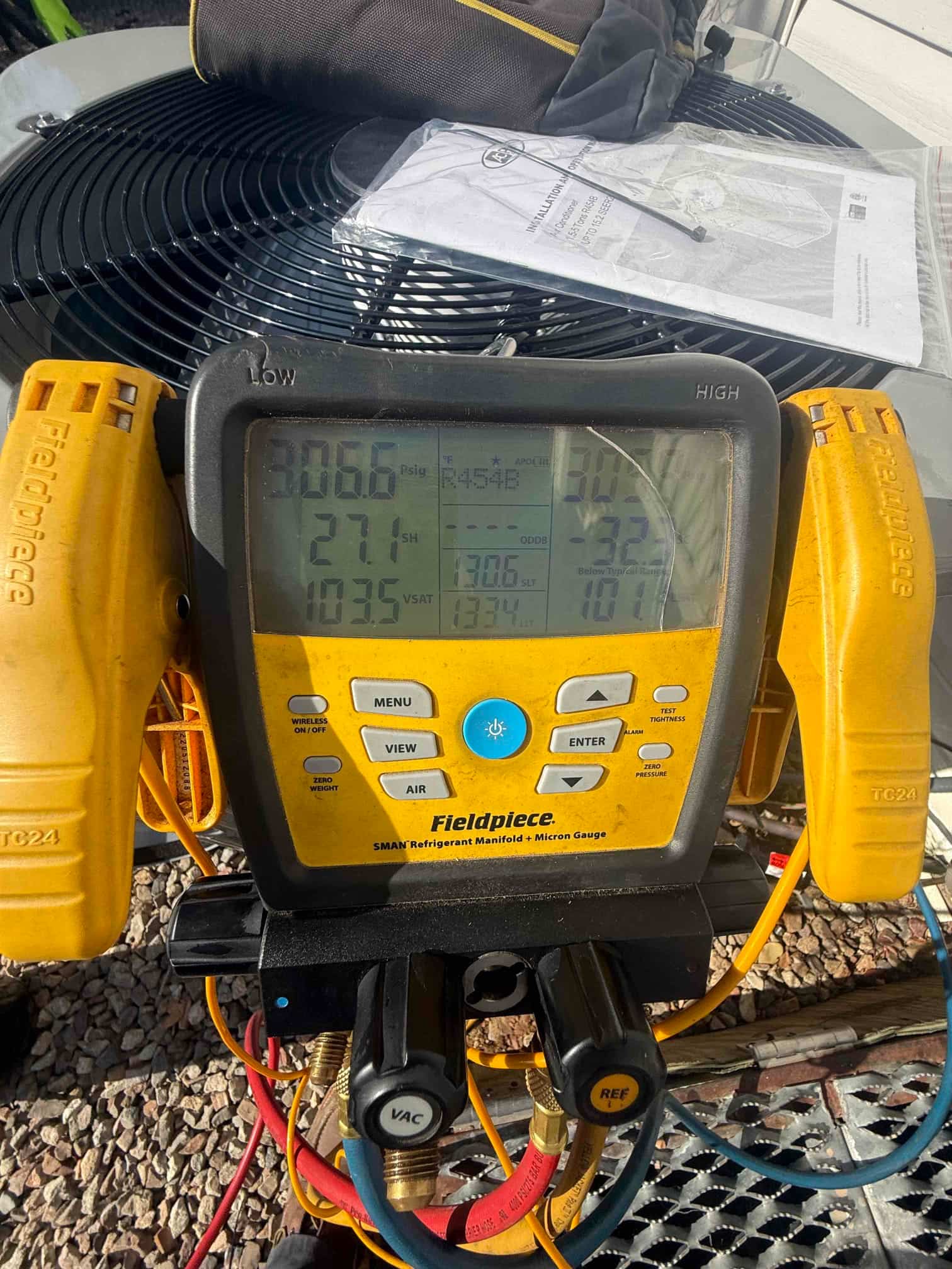 Digital manifold connected to the outdoor unit shows operating pressures while charging and tuning the new system with R-454B.
