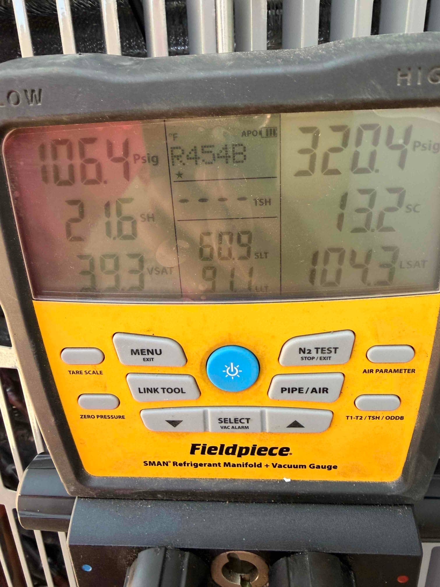 Digital manifold shows system operating pressures with refrigerant: low side 106.4 PSI and high side 320.4 PSI, refrigerant set to R-454B.