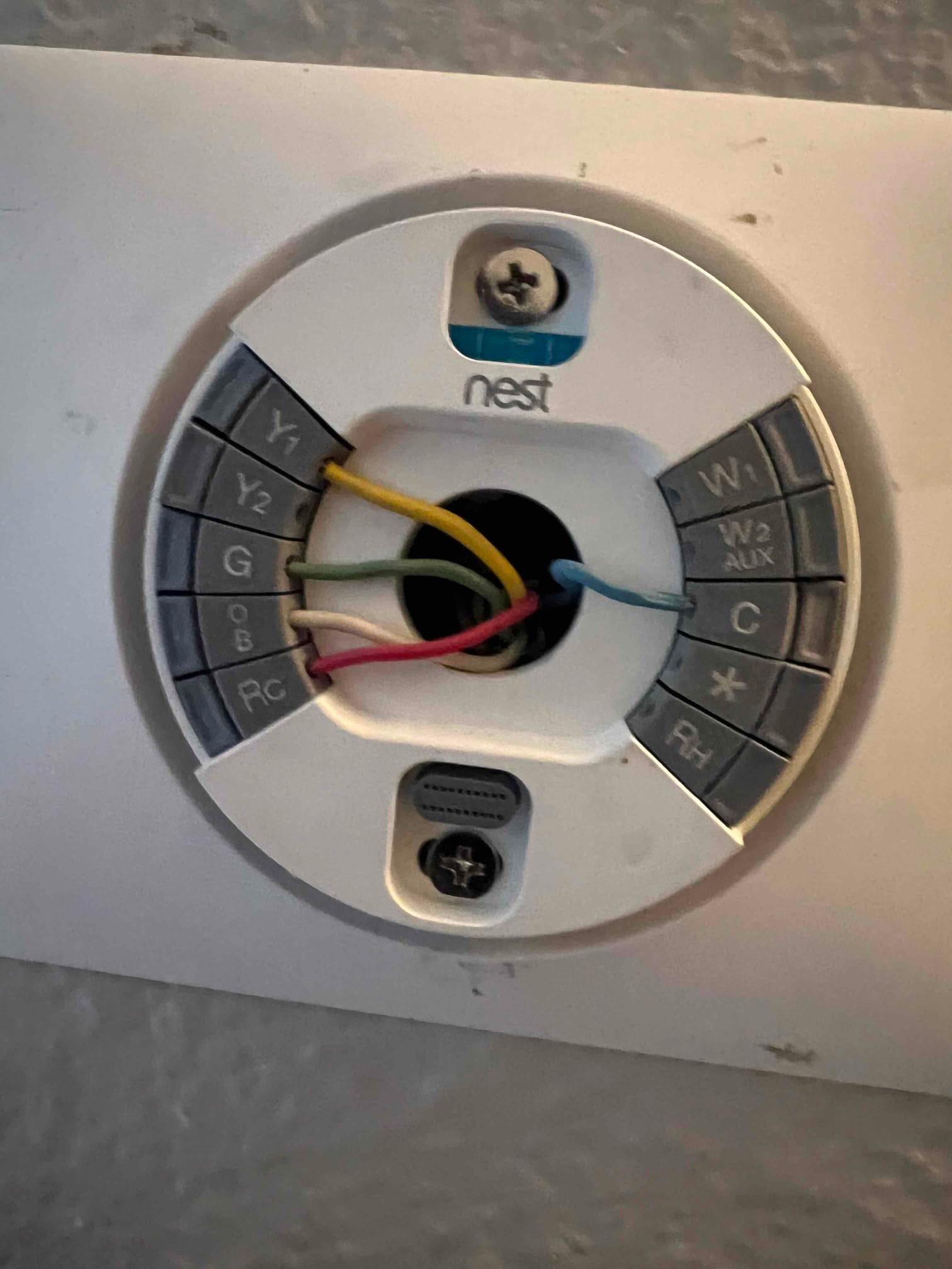 Thermostat base wiring with conductors landed on Y1, G, RC, and C terminals during installation and setup.