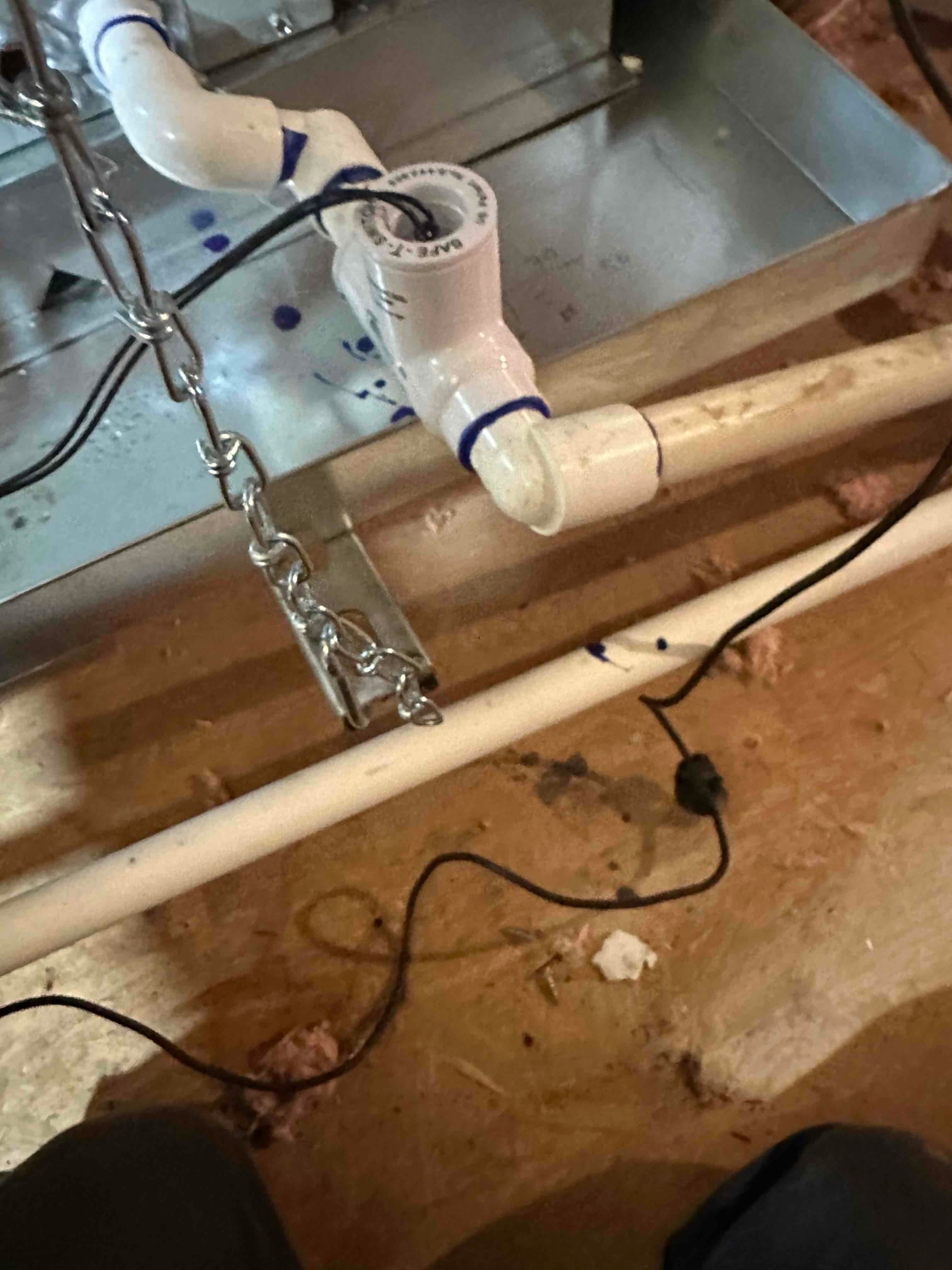 Condensate drain assembly with cleanout and trap connected to the air handler’s auxiliary drain pan in the attic.