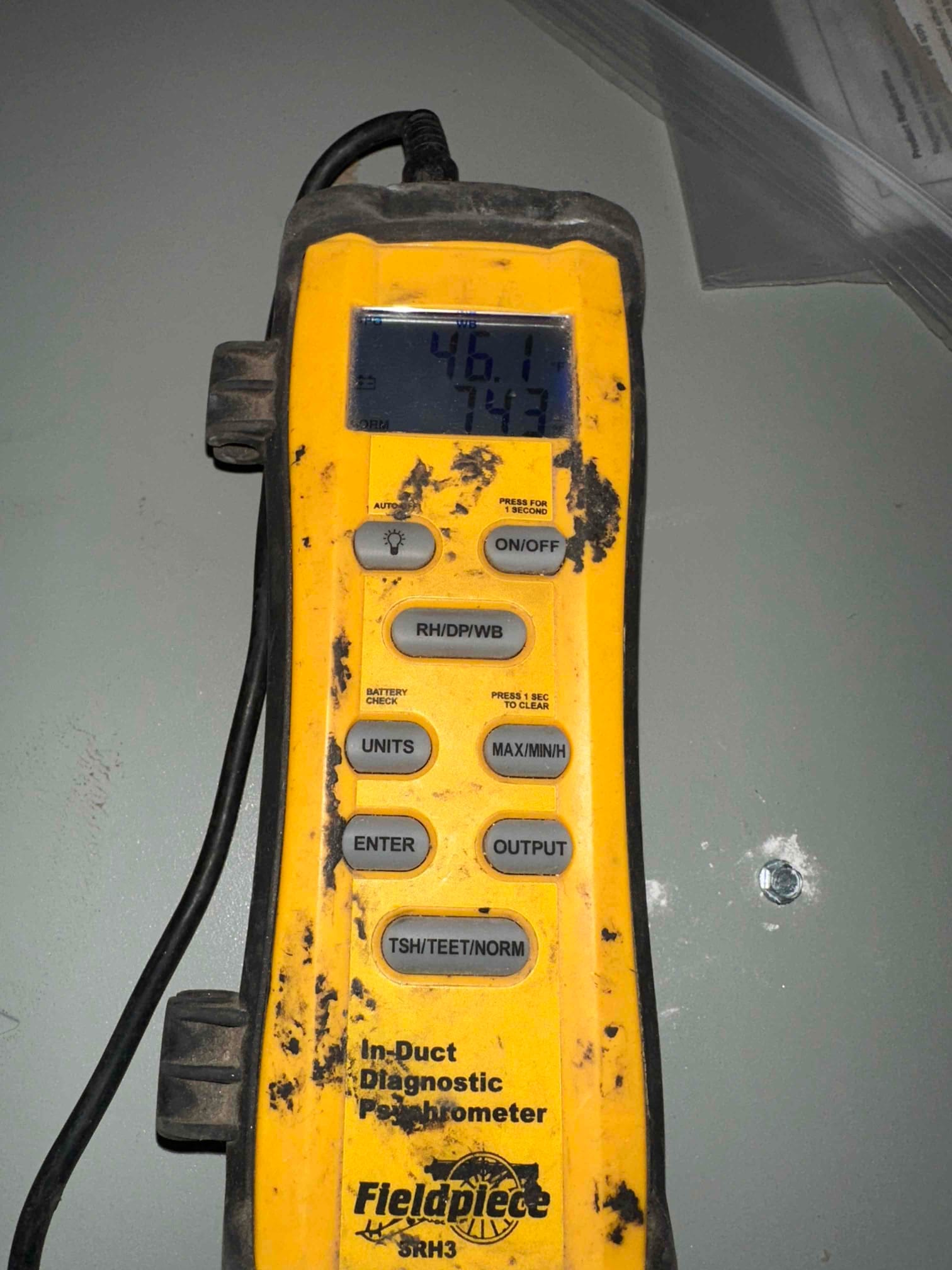 Digital psychrometer displays 74.3 degrees Fahrenheit air temperature during air-side commissioning on the new HVAC system.