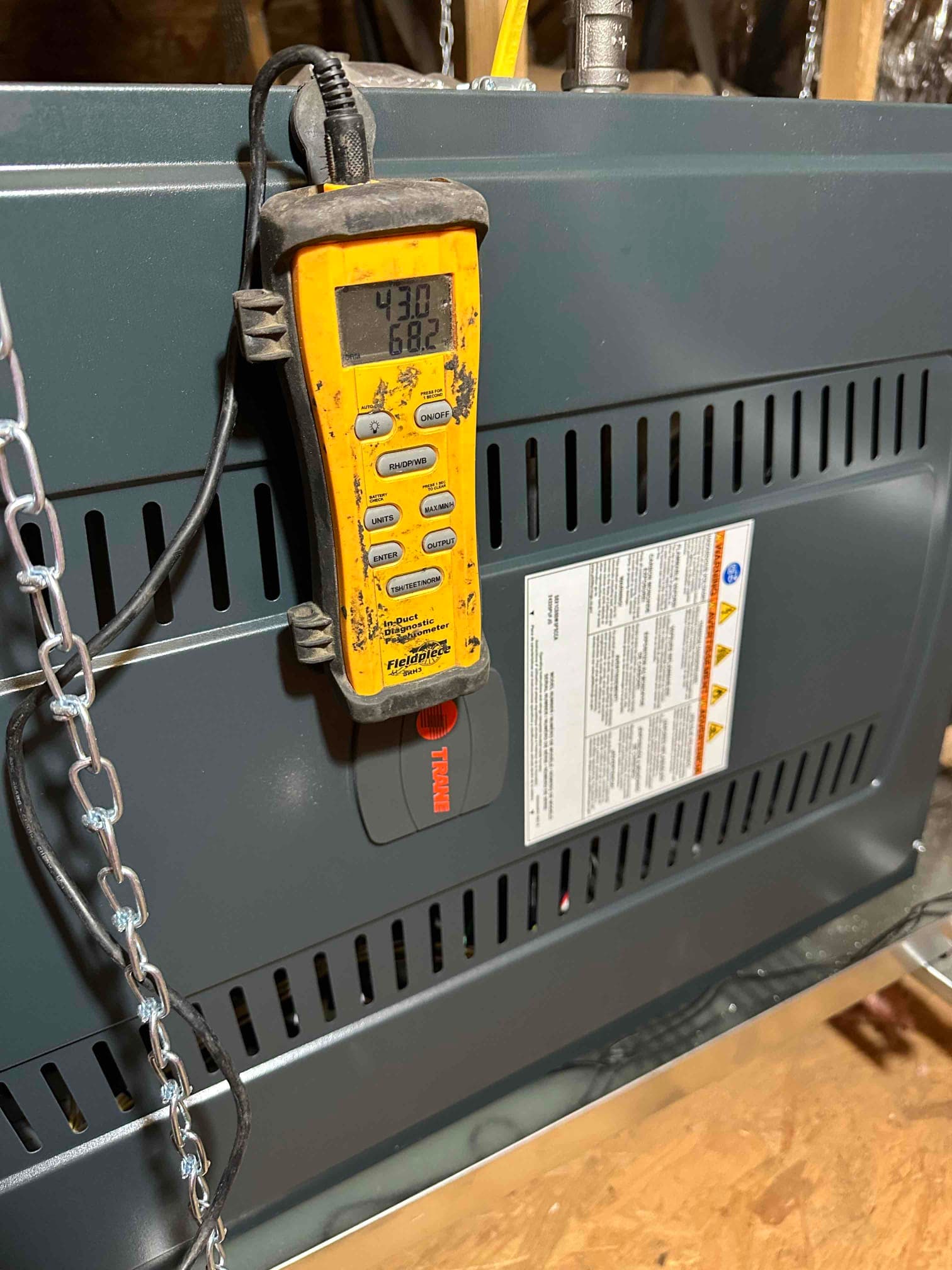 Digital thermometer attached to the furnace cabinet shows 43.0°F and 68.2°F during air temperature checks.