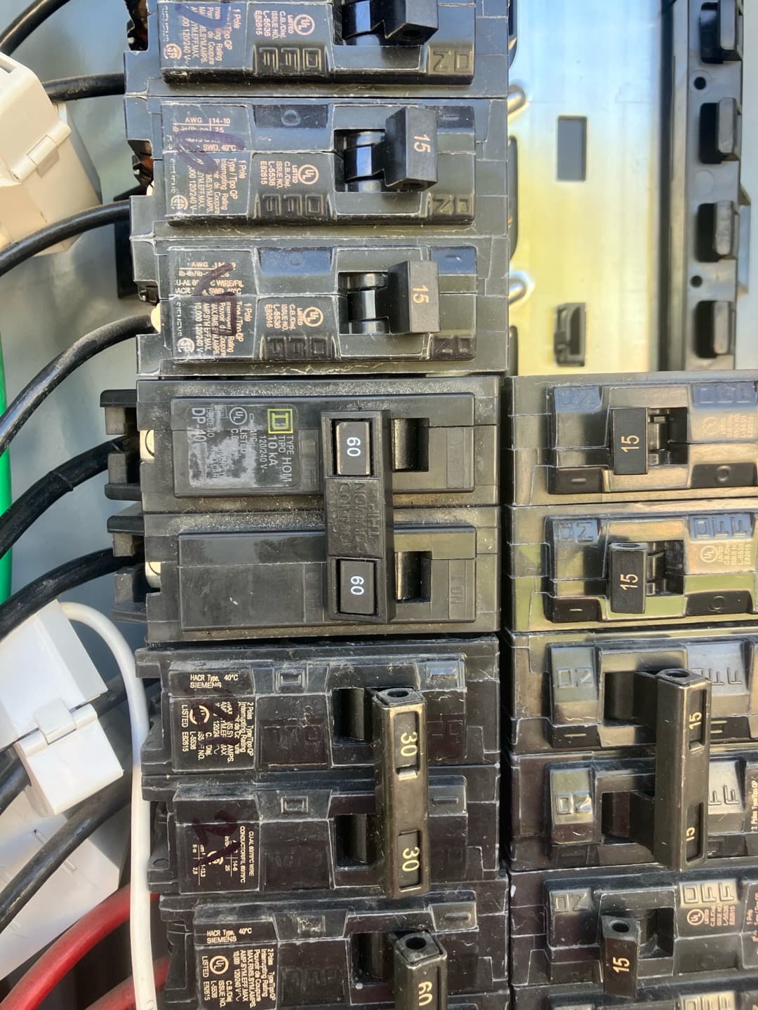 Electrical panel with multiple breakers, including a two-pole 60-amp breaker likely serving the HVAC package unit.