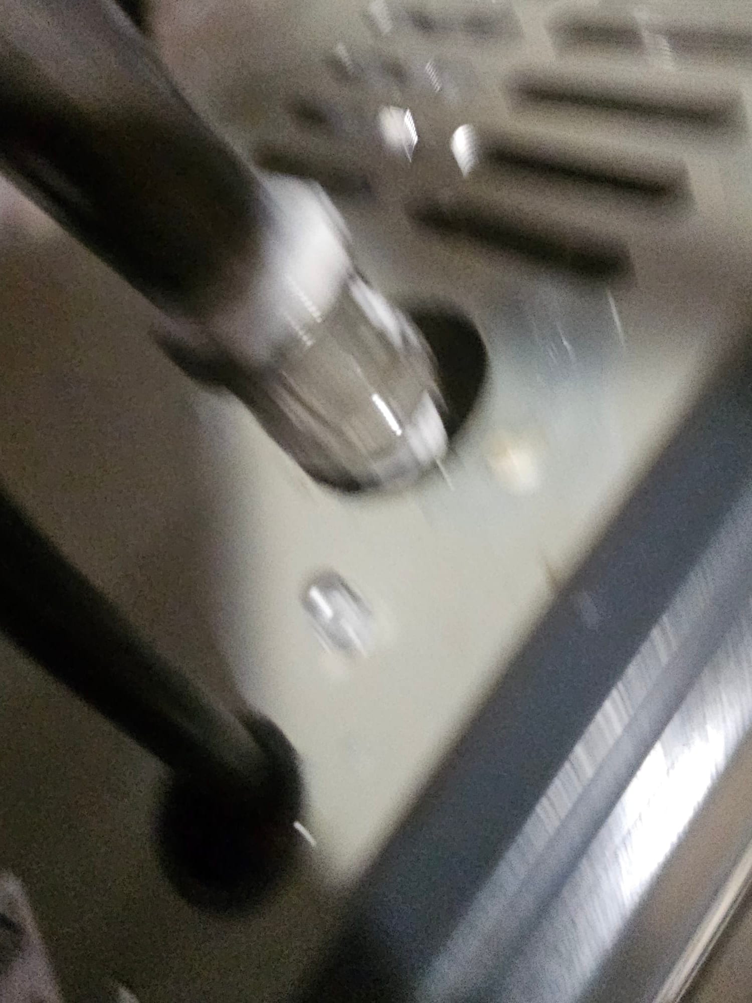 Close-up of insulated refrigerant lines entering the cabinet through a routed opening during HVAC installation.