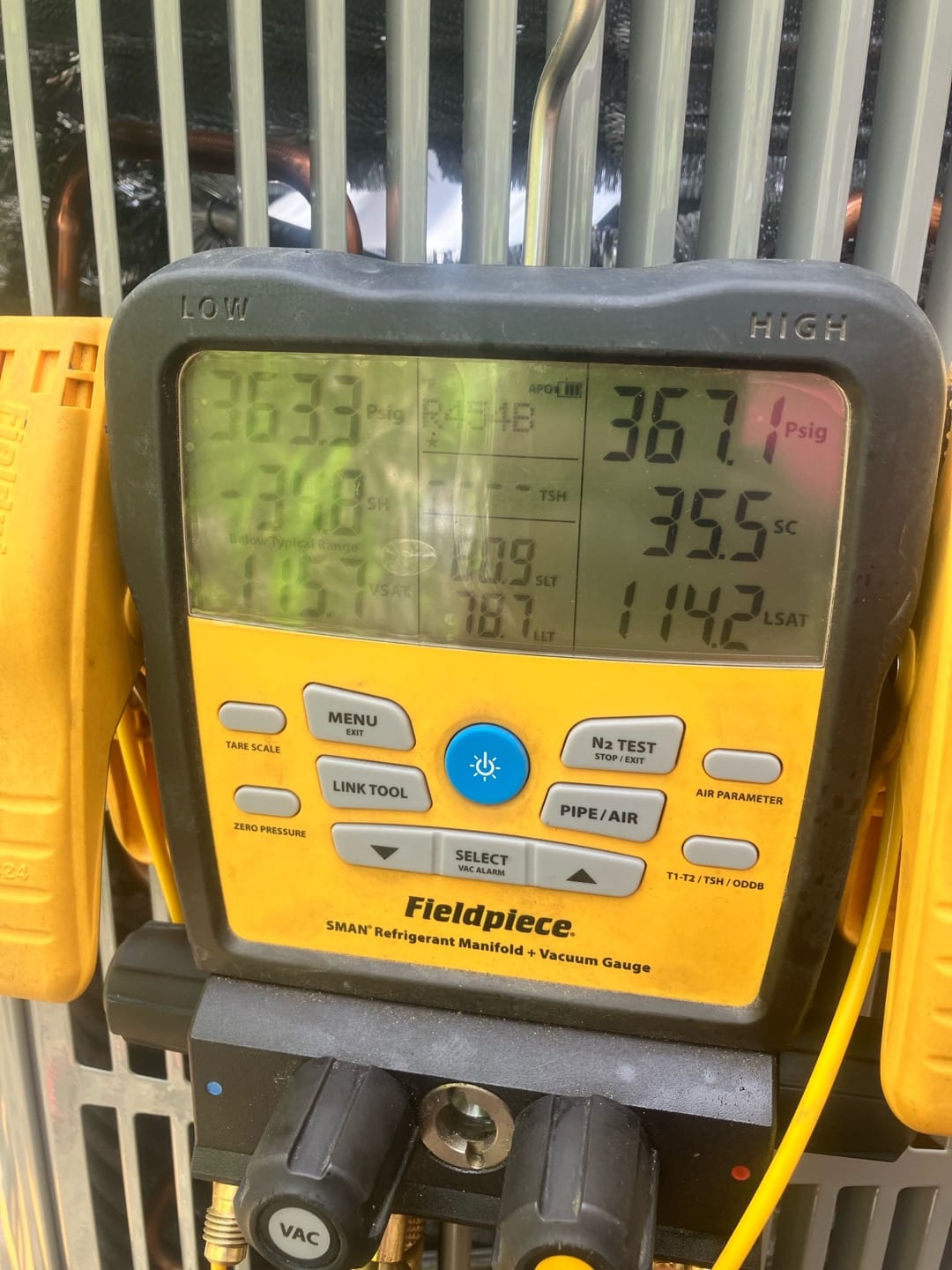 Digital manifold shows both high and low sides holding around 365 PSI during a nitrogen pressure test on the new system.