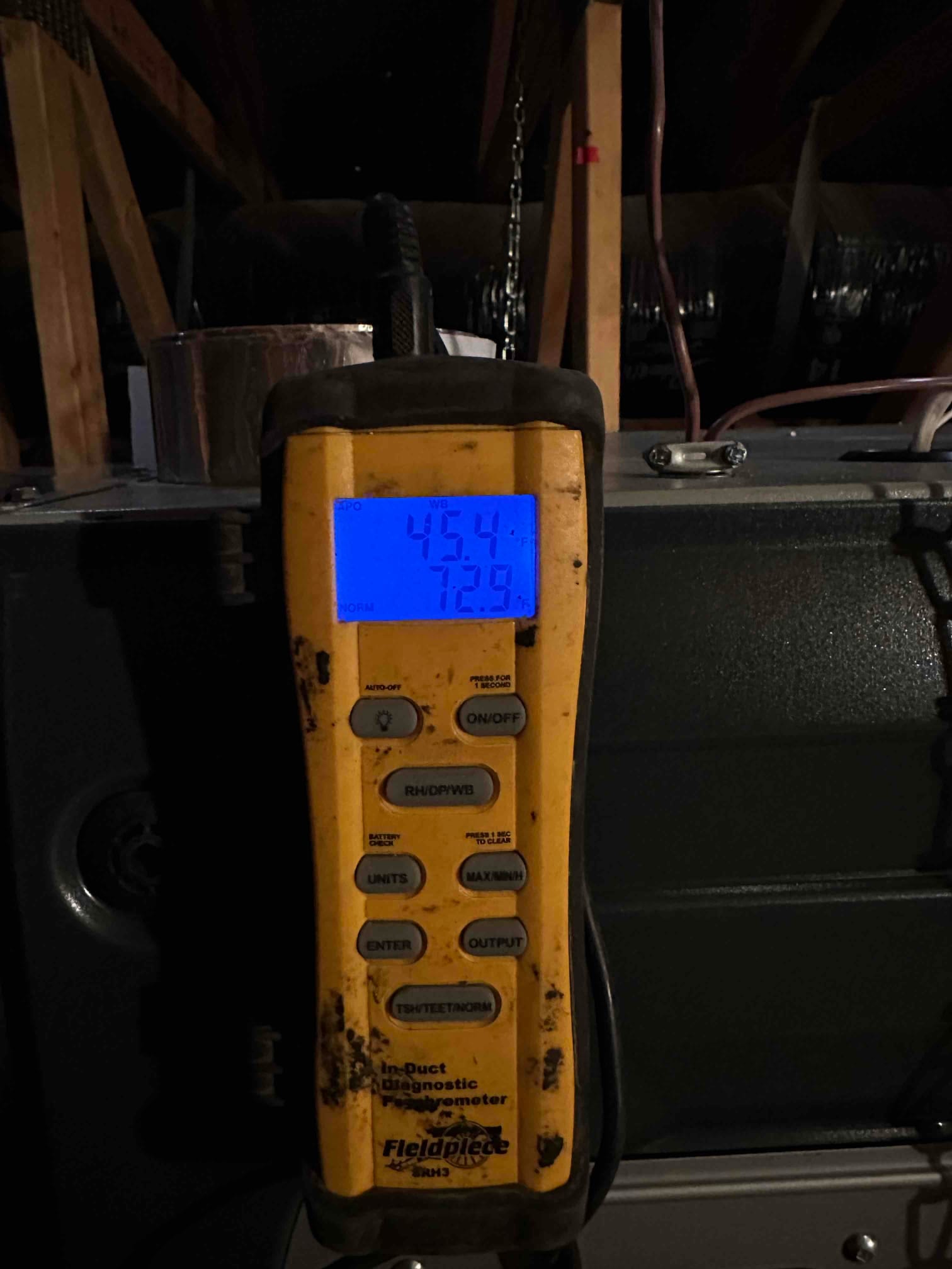 Digital thermometer displays 45.4°F and 72.9% relative humidity while measuring air temperature at the newly installed system.