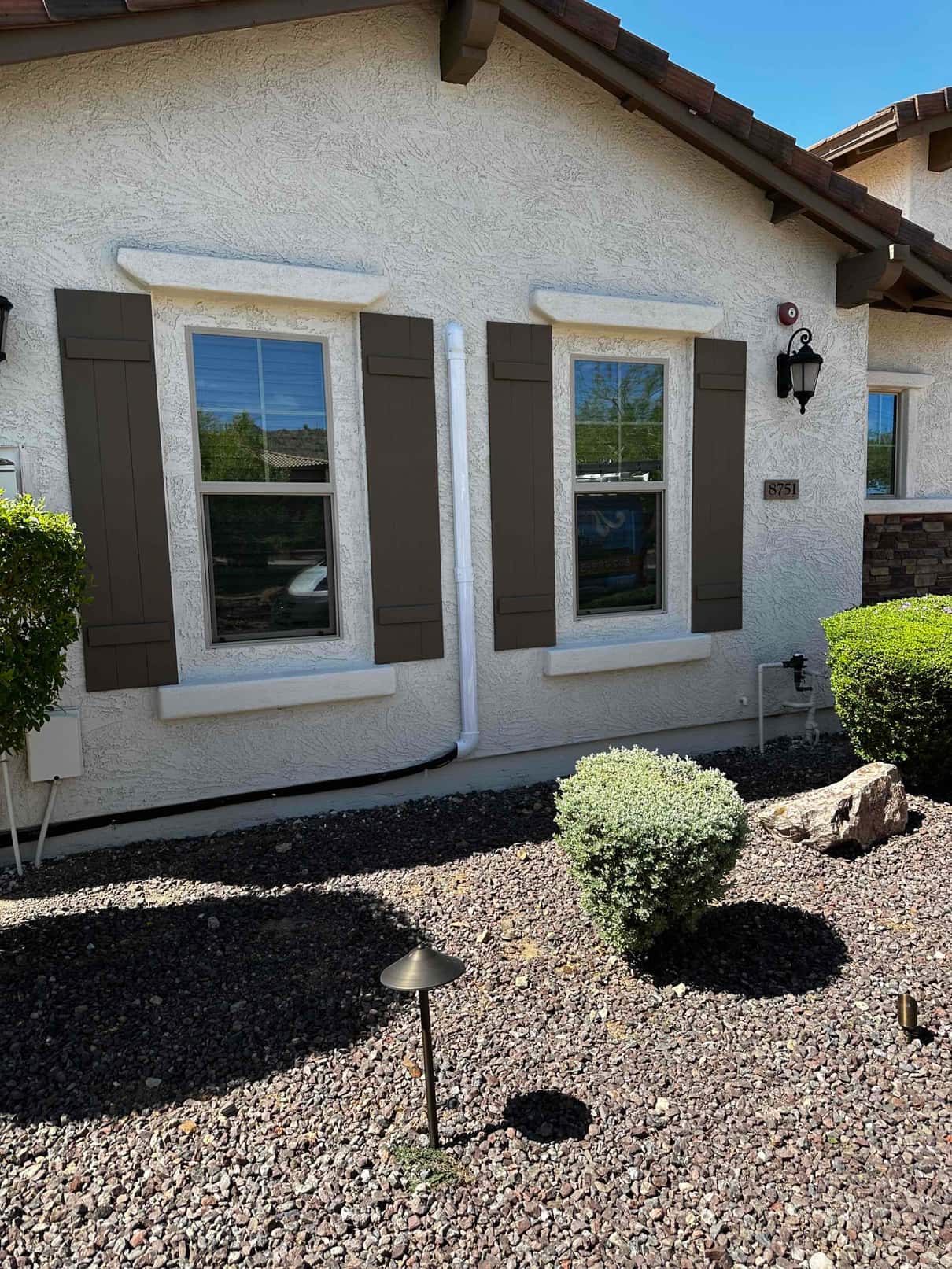 Exterior wall shows newly routed mini‑split line set in a protective cover with sealed wall penetrations along the foundation.