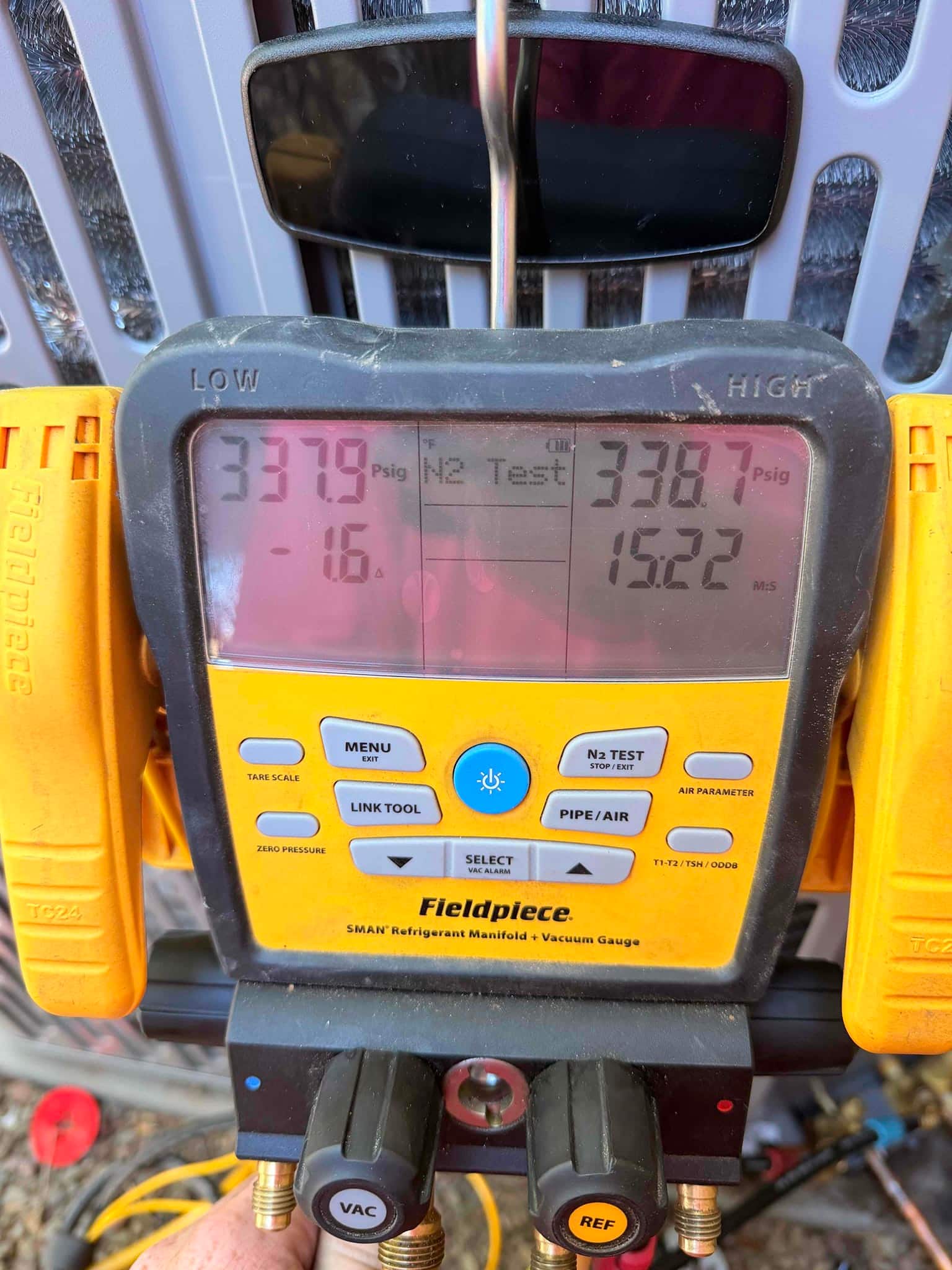 Digital manifold set to nitrogen test shows equalized pressures around 338 PSI on both low and high sides.