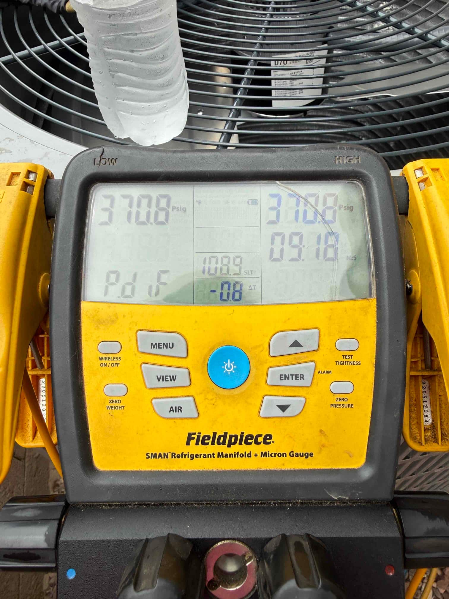 Digital manifold shows equal pressures of 370 PSI on both sides during a nitrogen pressure test at the outdoor unit.