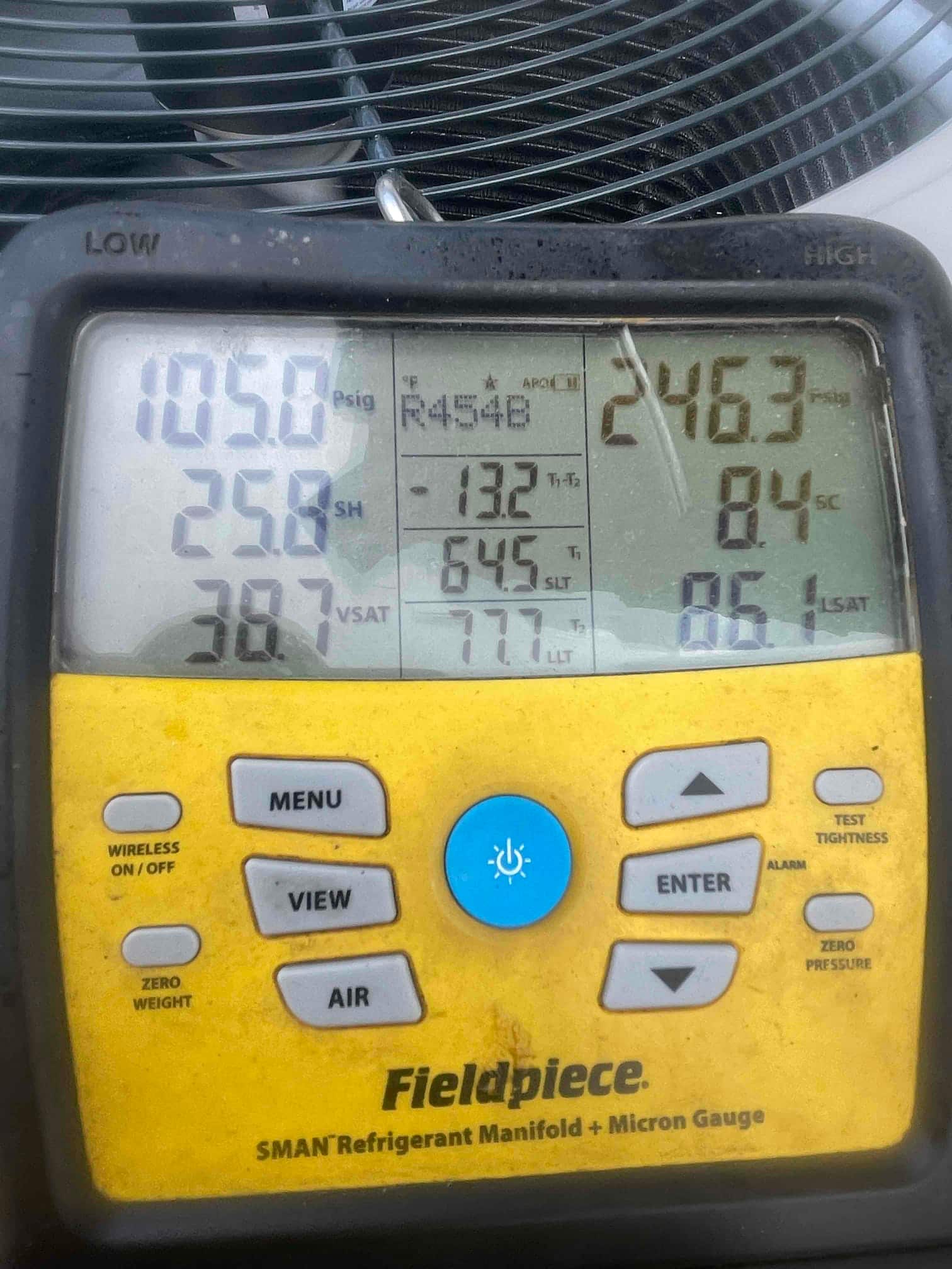 Digital manifold shows operating pressures and temperatures while commissioning the outdoor unit during cooling operation.