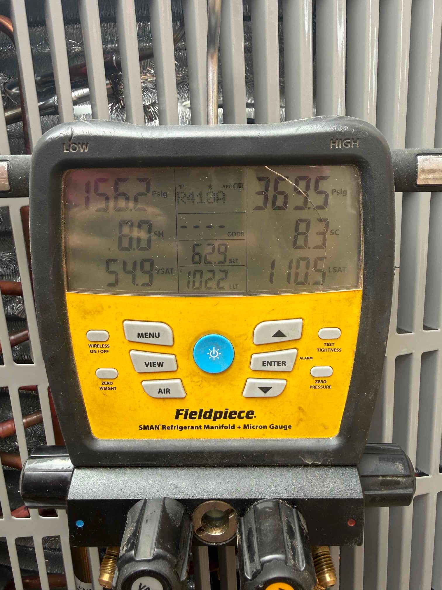 Digital manifold shows system operating pressures with R-410A: approximately 156 PSI suction and 369 PSI liquid. Superheat and subcooling displayed.