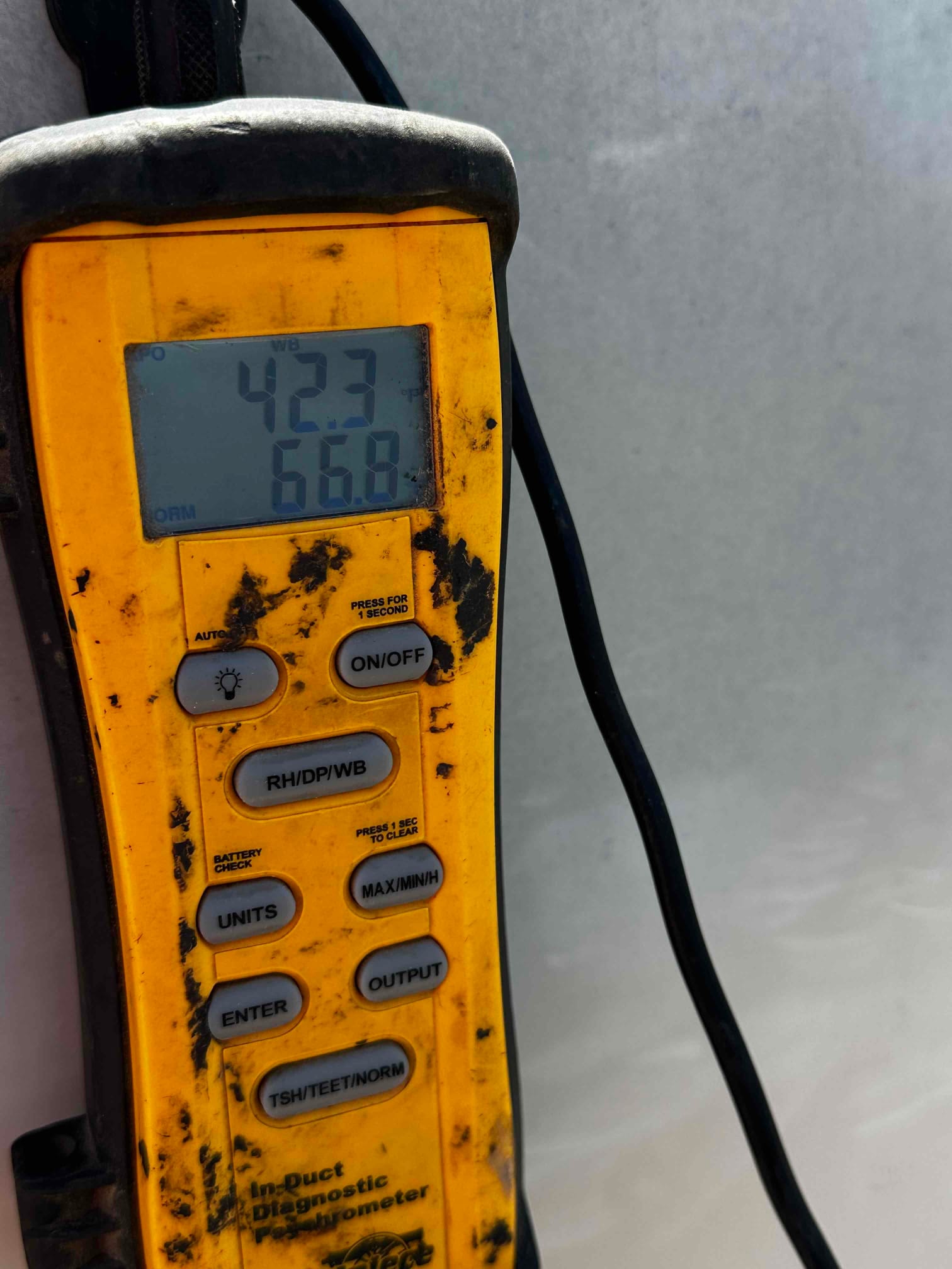 Digital thermometer displays 42.3°F and 66.8°F during air temperature checks on the newly installed system.