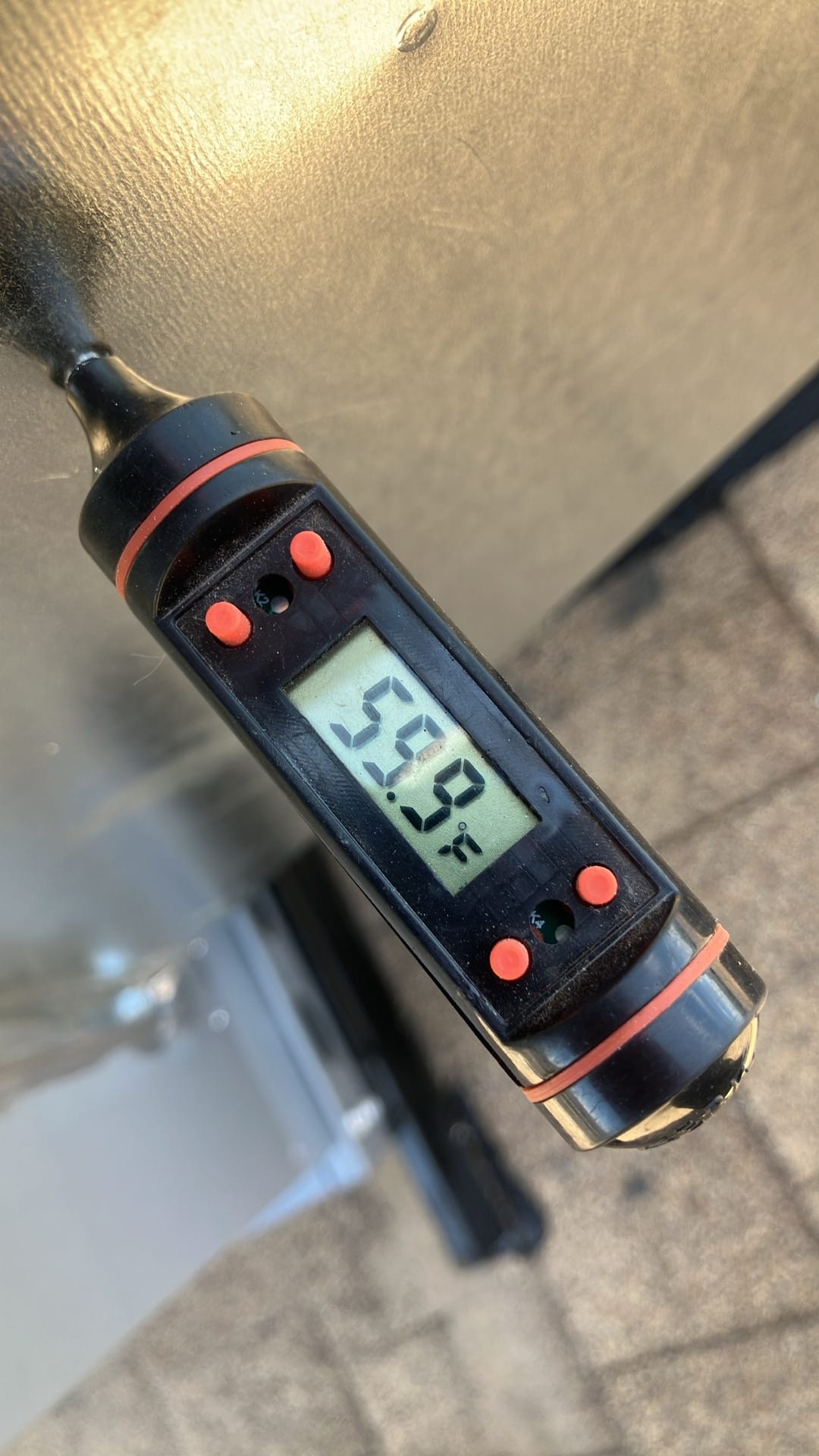 Digital thermometer shows 59.8°F, documenting supply air temperature leaving the evaporator during cooling operation.