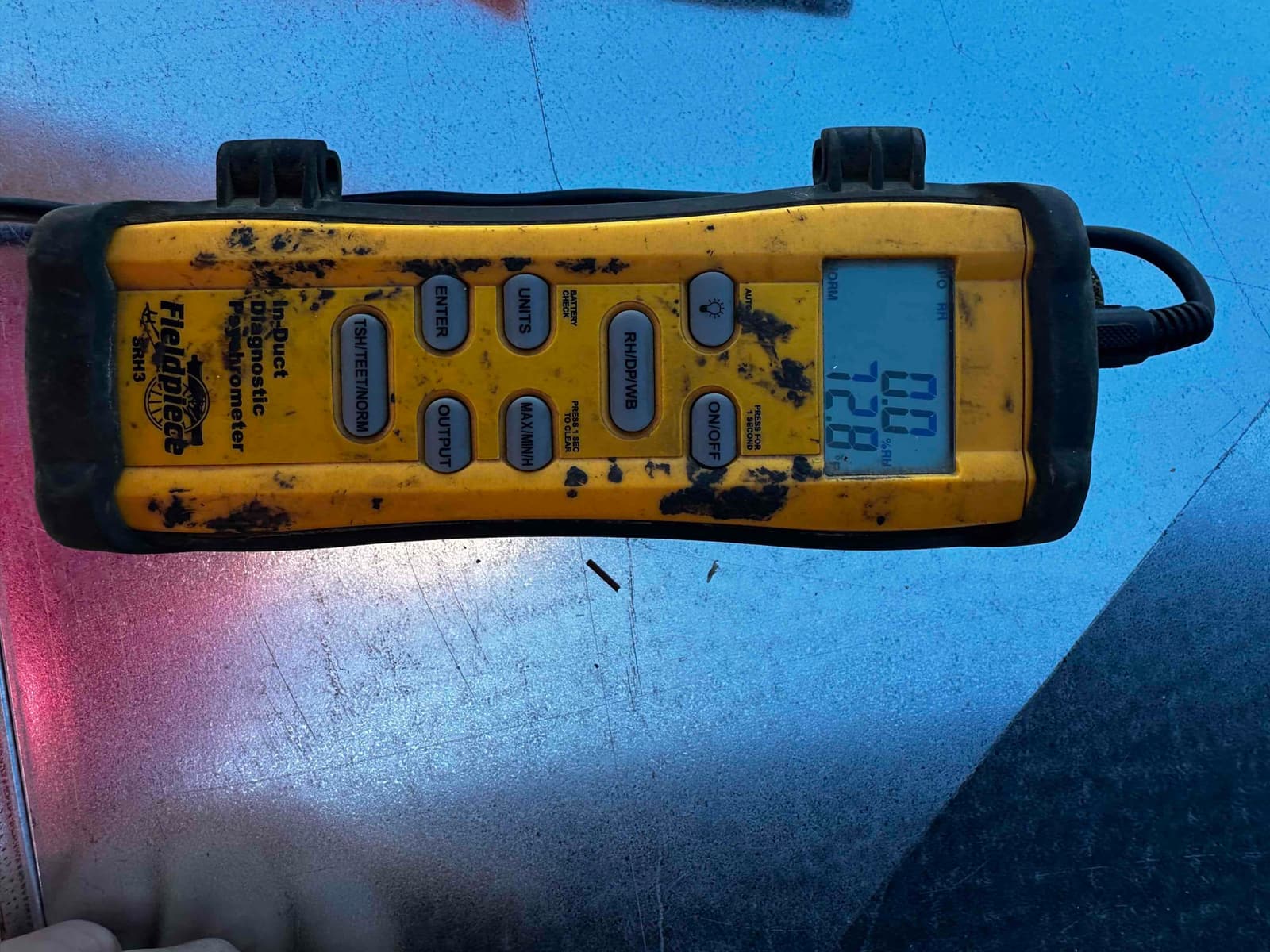 In-duct diagnostic anemometer displays airflow measurements on its screen while checking the HVAC system’s air side performance.