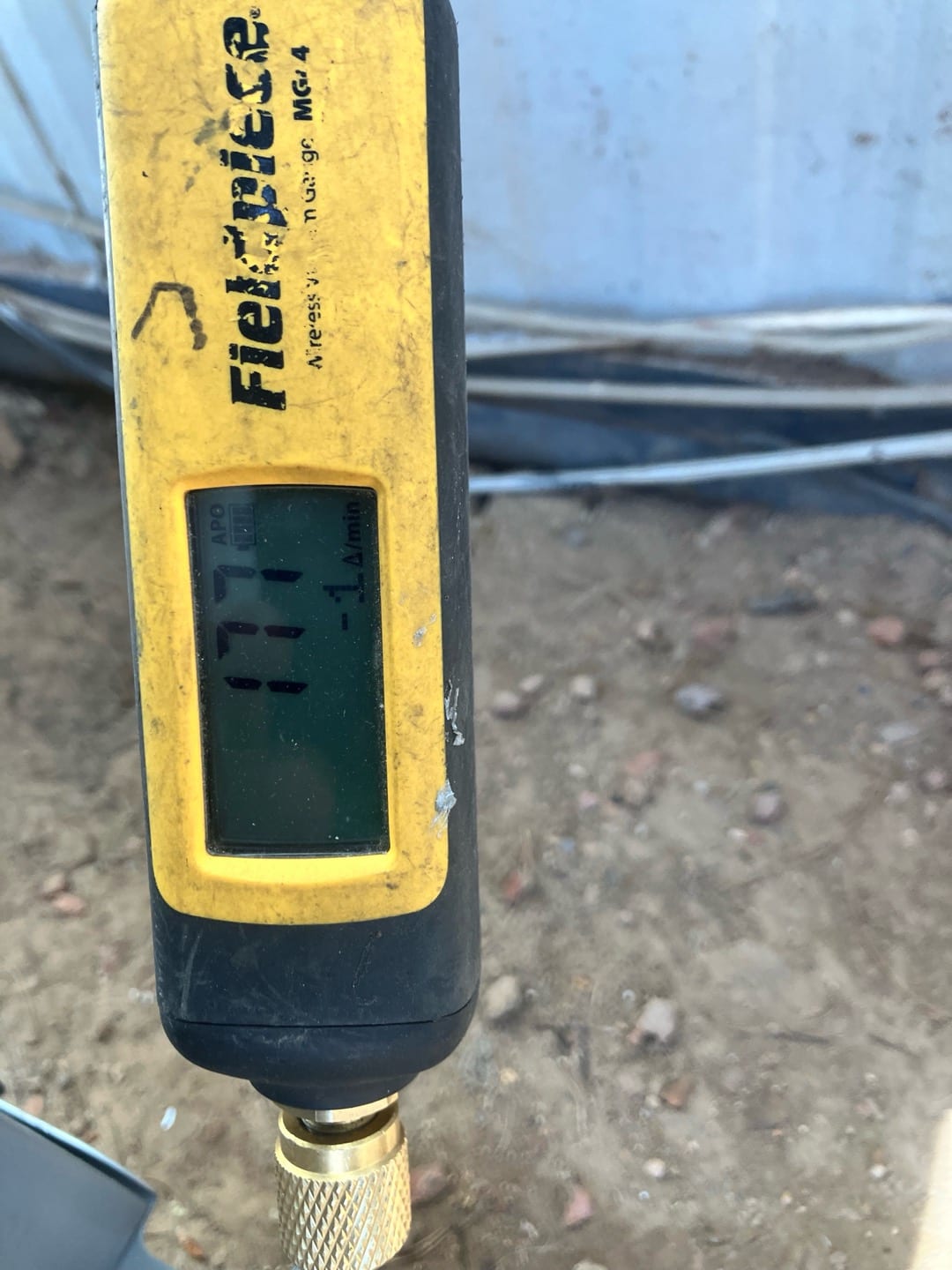 Micron gauge reads 177 microns during evacuation, confirming a deep vacuum before introducing refrigerant to the new system.