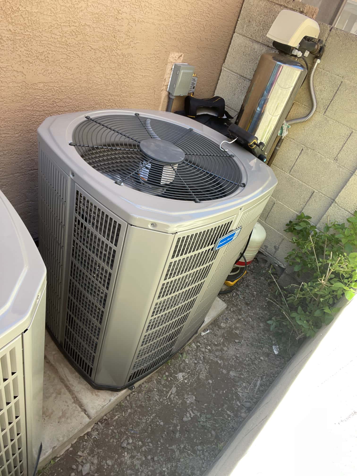 New outdoor condensers set on level pads with electrical disconnect nearby and clear service access along the side yard.
