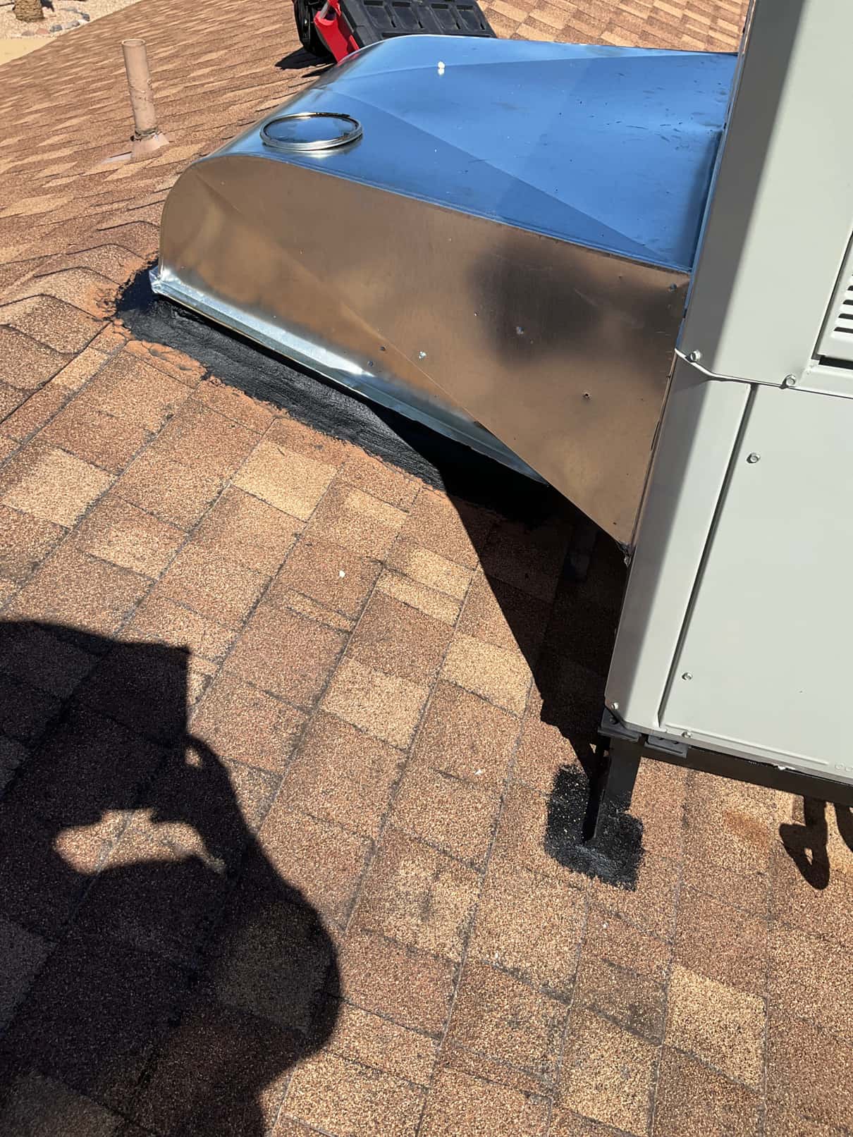 Roof-mounted package unit with newly fabricated supply/return transition and sealed flashing integrated into the shingle roof.