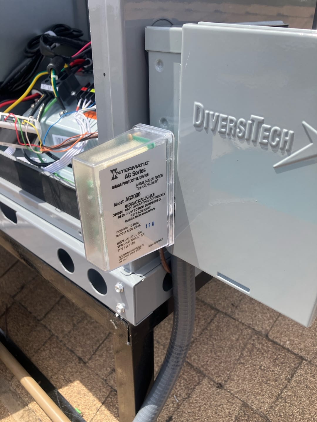 Surge protective device installed at the outdoor disconnect with wiring routed through conduit to the HVAC unit.