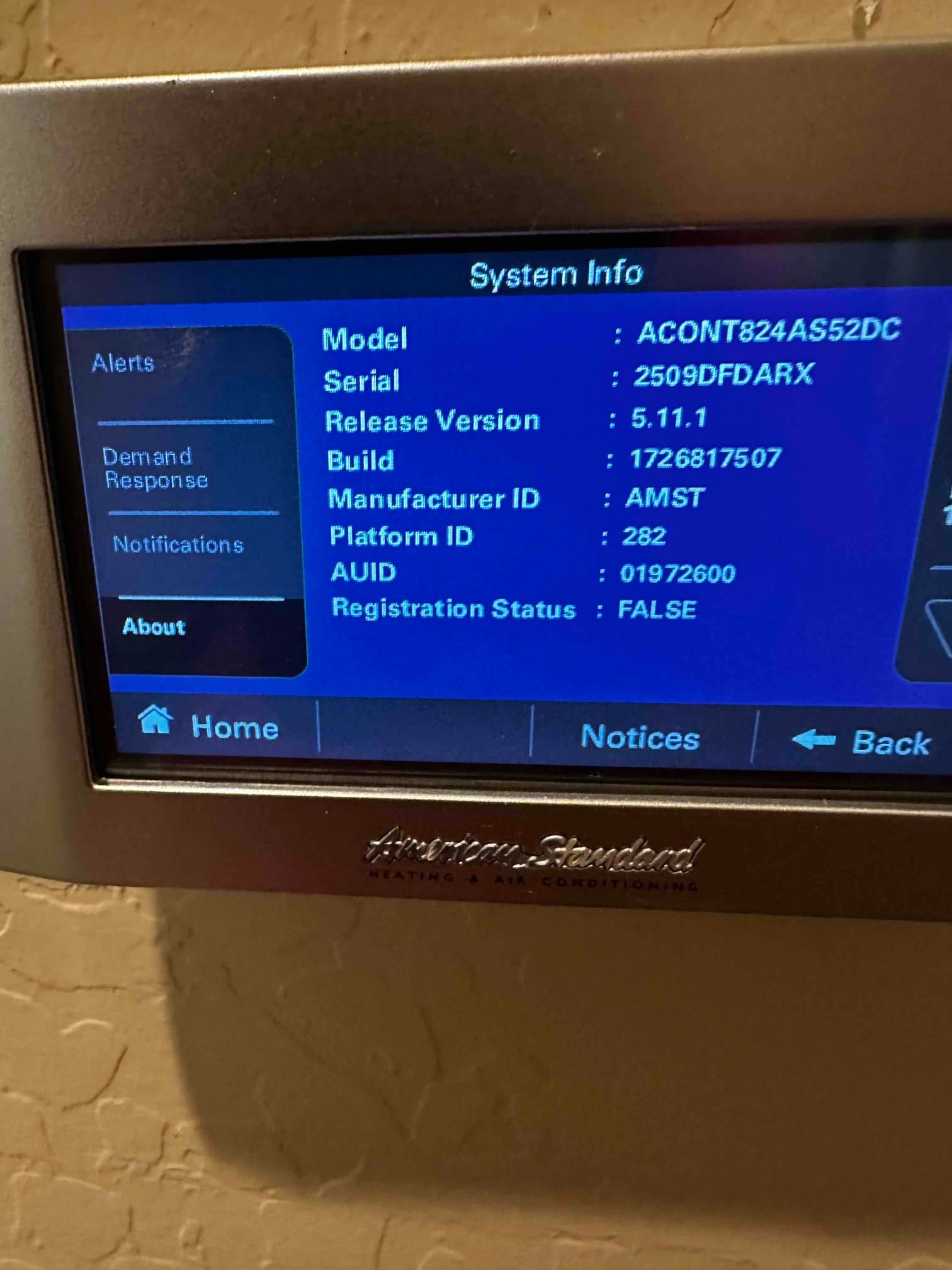 Thermostat screen displays system information menu with model, serial, software version, and registration status after installation.