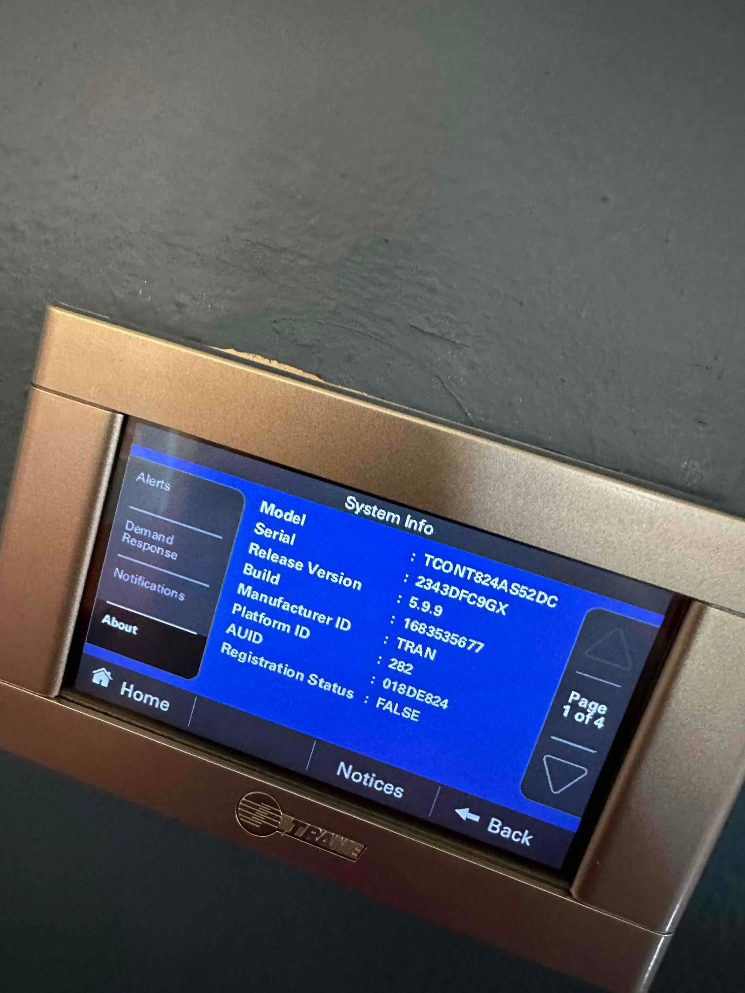 Wall-mounted touchscreen thermostat displaying system information menu after installation and setup is complete.