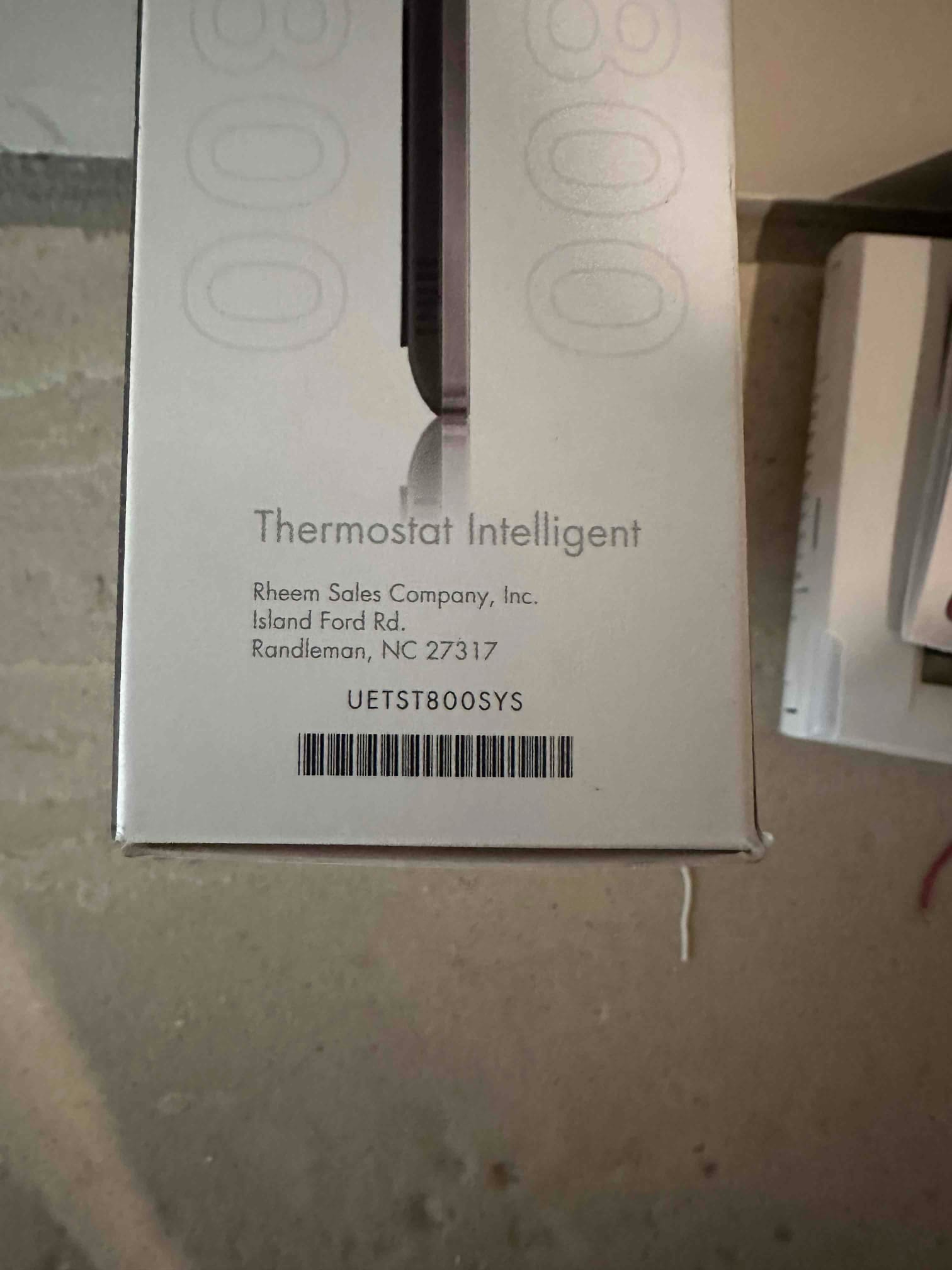 Box for a smart thermostat on the job site, indicating new control installation as part of the HVAC system upgrade.