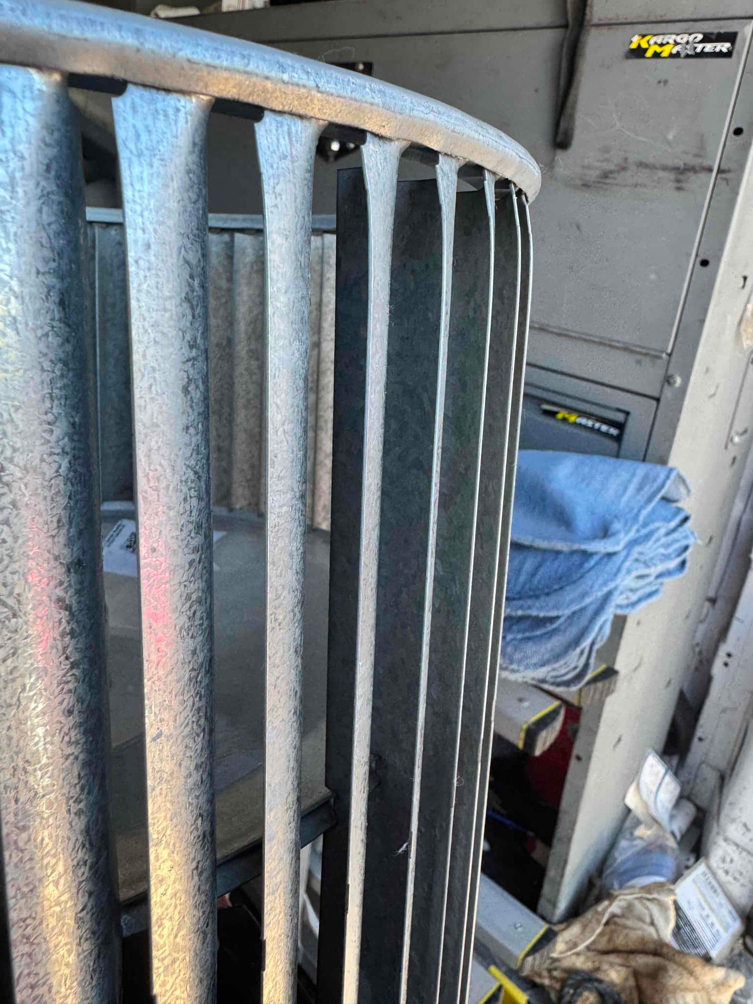 Cleaned blower wheel with straightened vanes positioned for reinstallation, showing uniform spacing and clean galvanized metal surfaces.