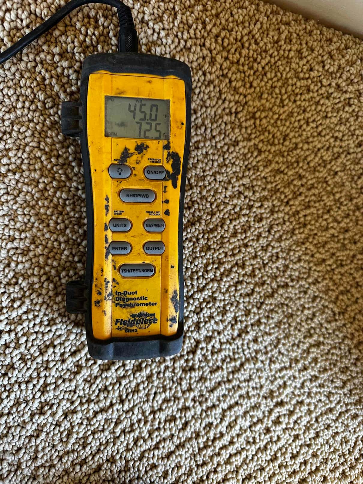 Digital in-duct thermometer shows 72.5 degrees Fahrenheit return air during airside commissioning of the new system.