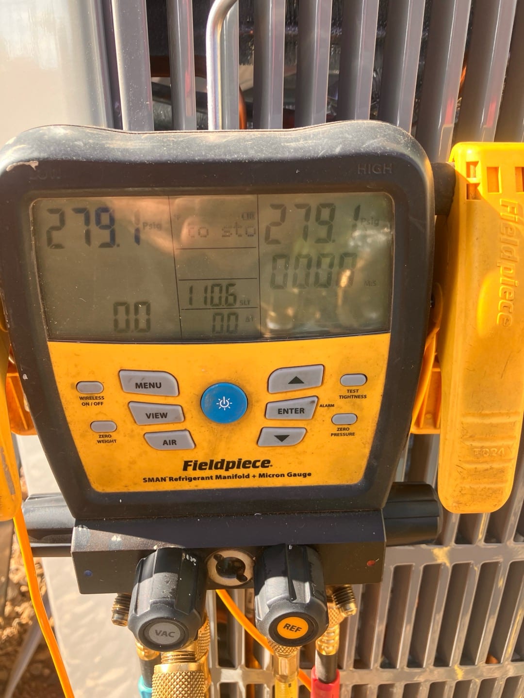 Digital manifold shows equal pressures of 279 PSI on both sides during a nitrogen pressure test at the outdoor unit.