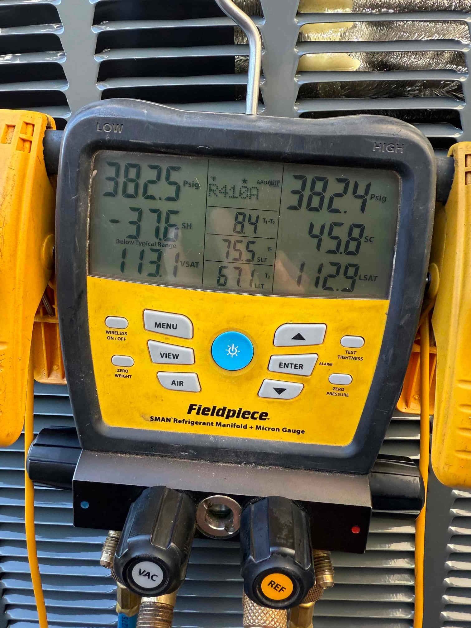 Digital manifold shows equal pressures around 382 PSI on both sides, documenting a nitrogen pressure test on the new system.