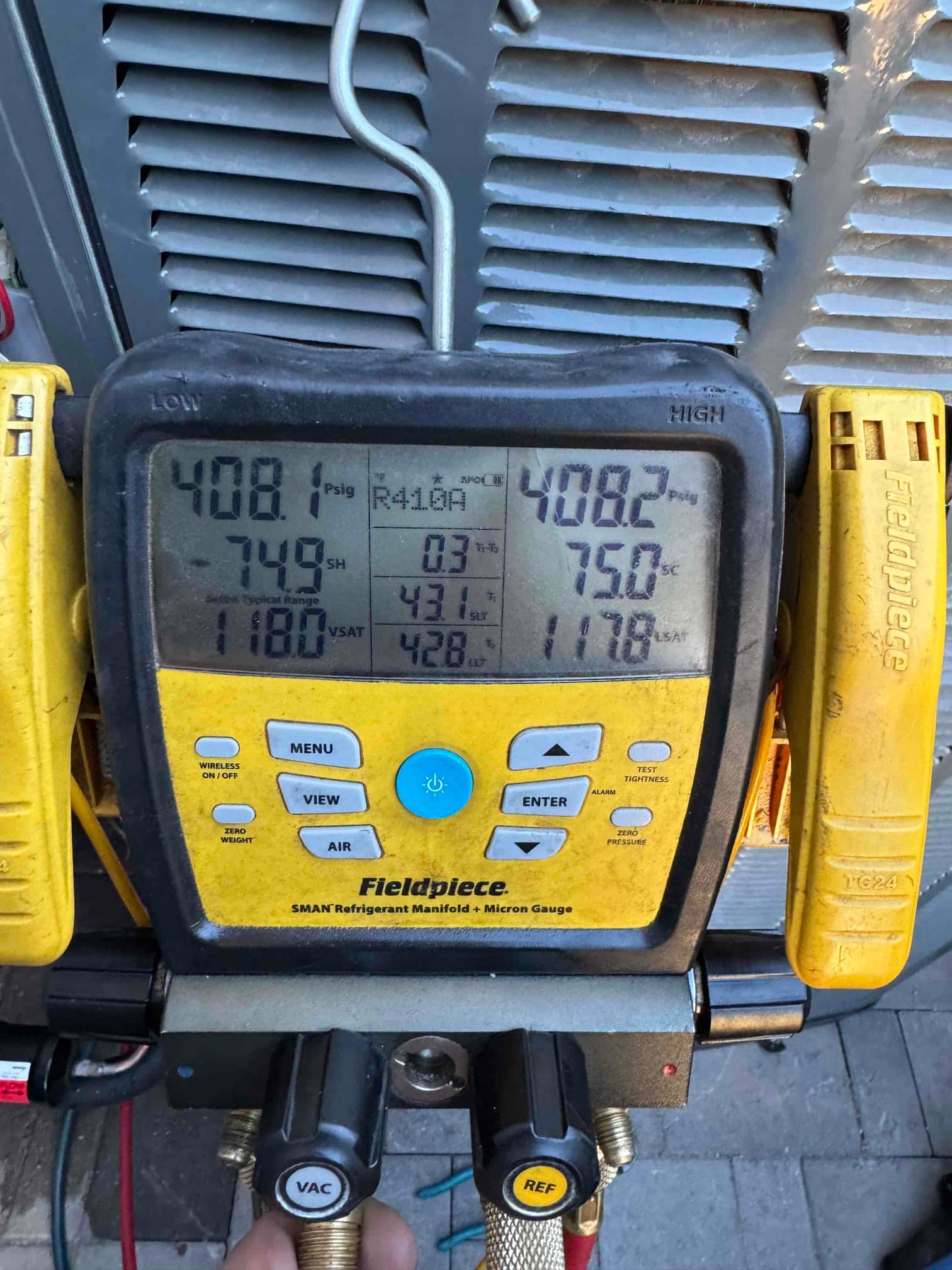Digital manifold shows both low and high sides holding about 408 PSI, documenting a nitrogen pressure test on the new system.