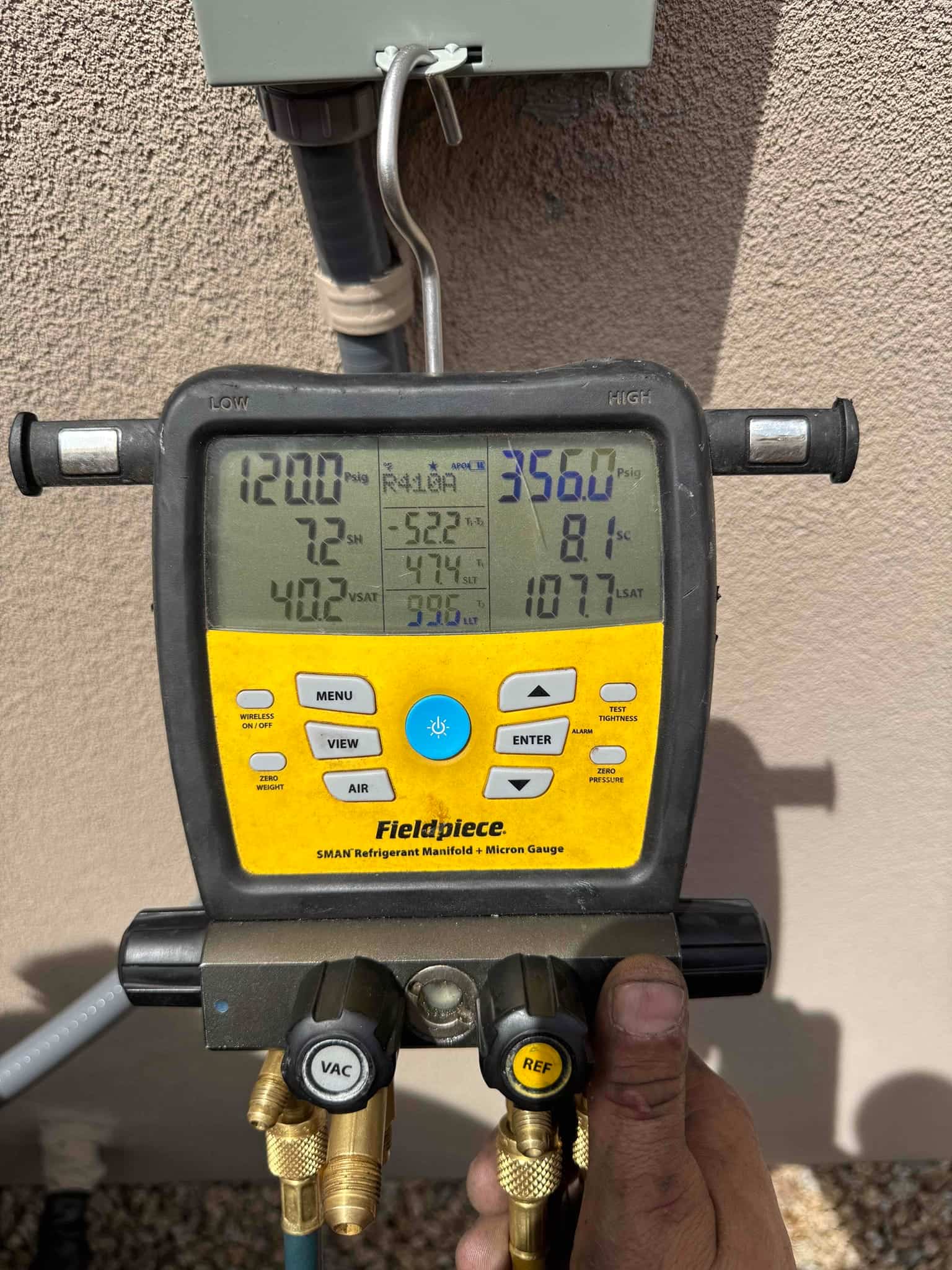 Digital manifold shows operating pressures with low side at 120 PSI and high side at 356 PSI during system commissioning.