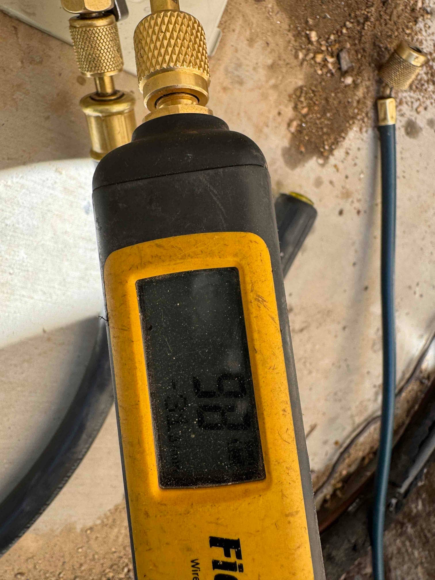 Digital micron gauge connected to the system shows a deep vacuum during evacuation before releasing refrigerant.