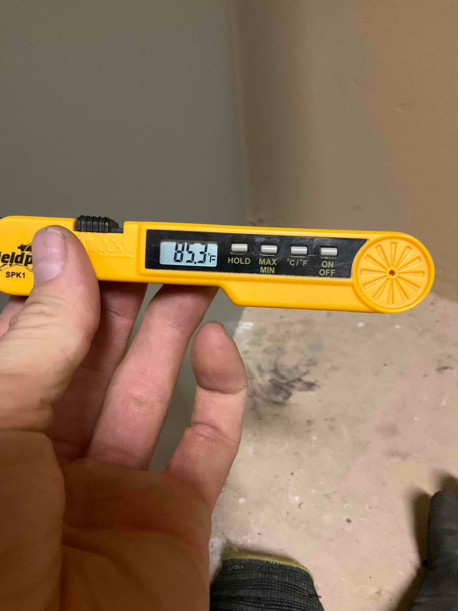 Digital thermometer displays 85.3°F during air temperature check as part of system commissioning.