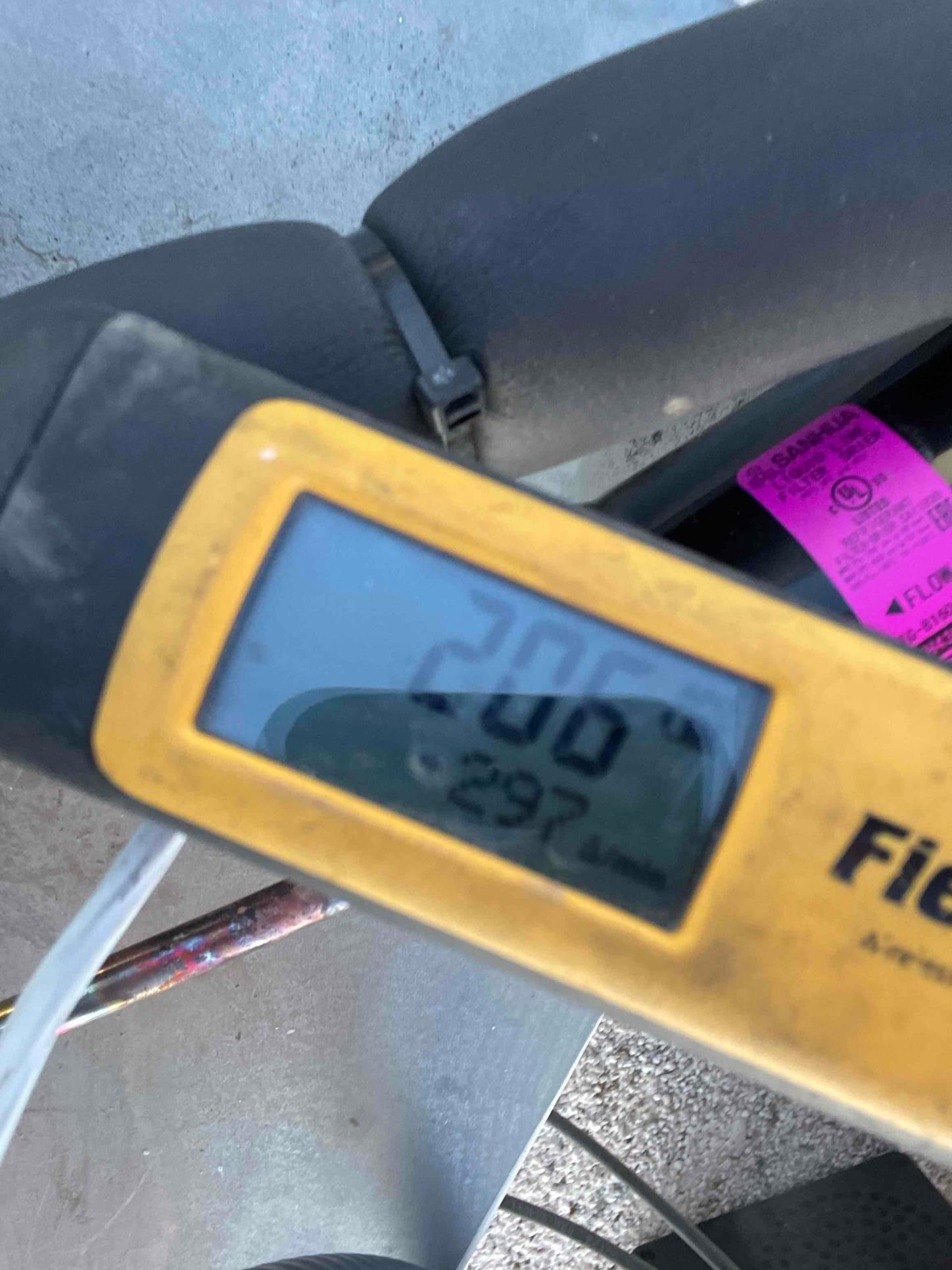 Micron gauge displays 297 microns during evacuation, confirming a deep vacuum before introducing refrigerant to the system.