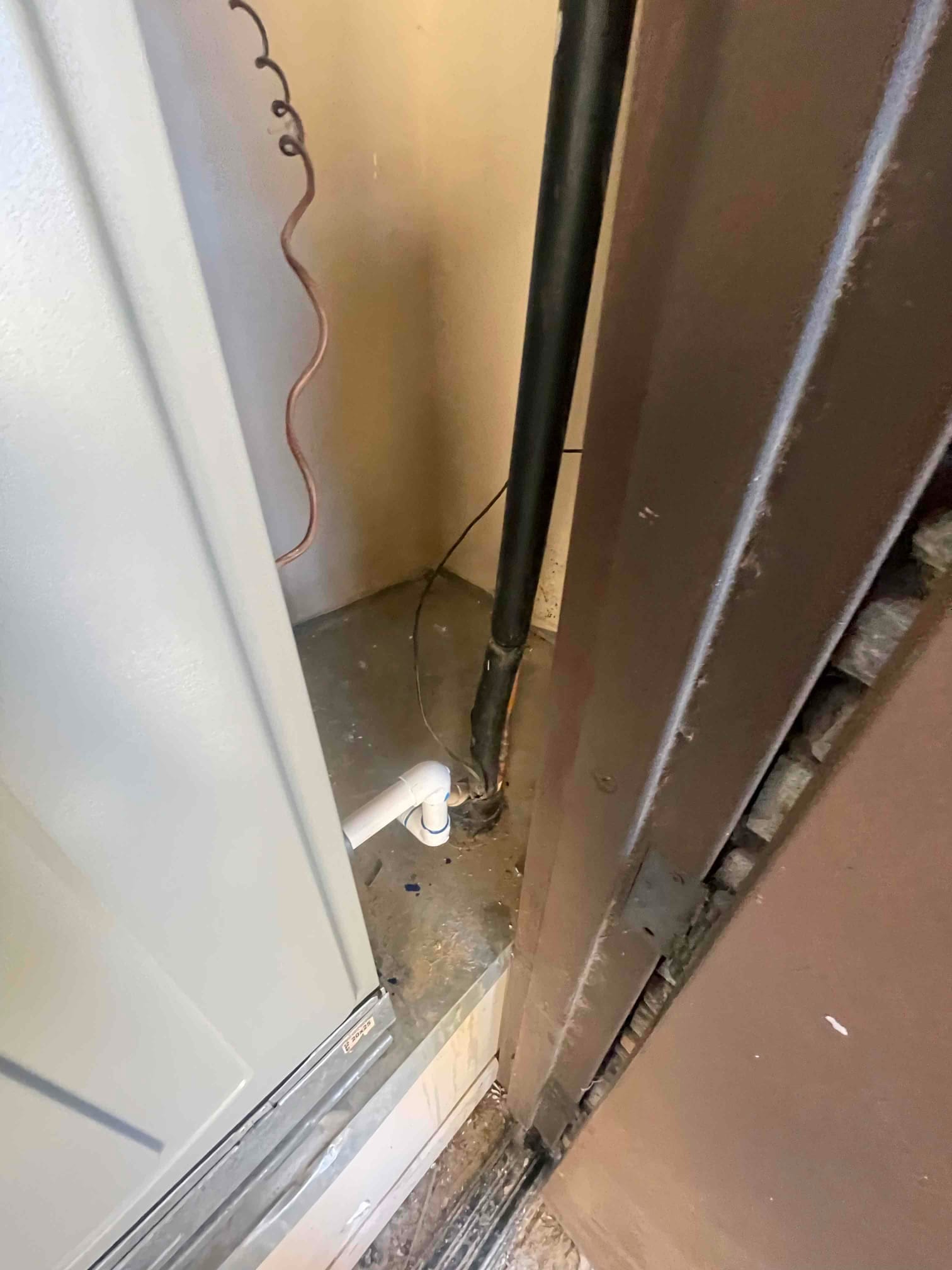 New furnace platform with insulated refrigerant line set penetration and PVC condensate drain connection routed beside the unit.