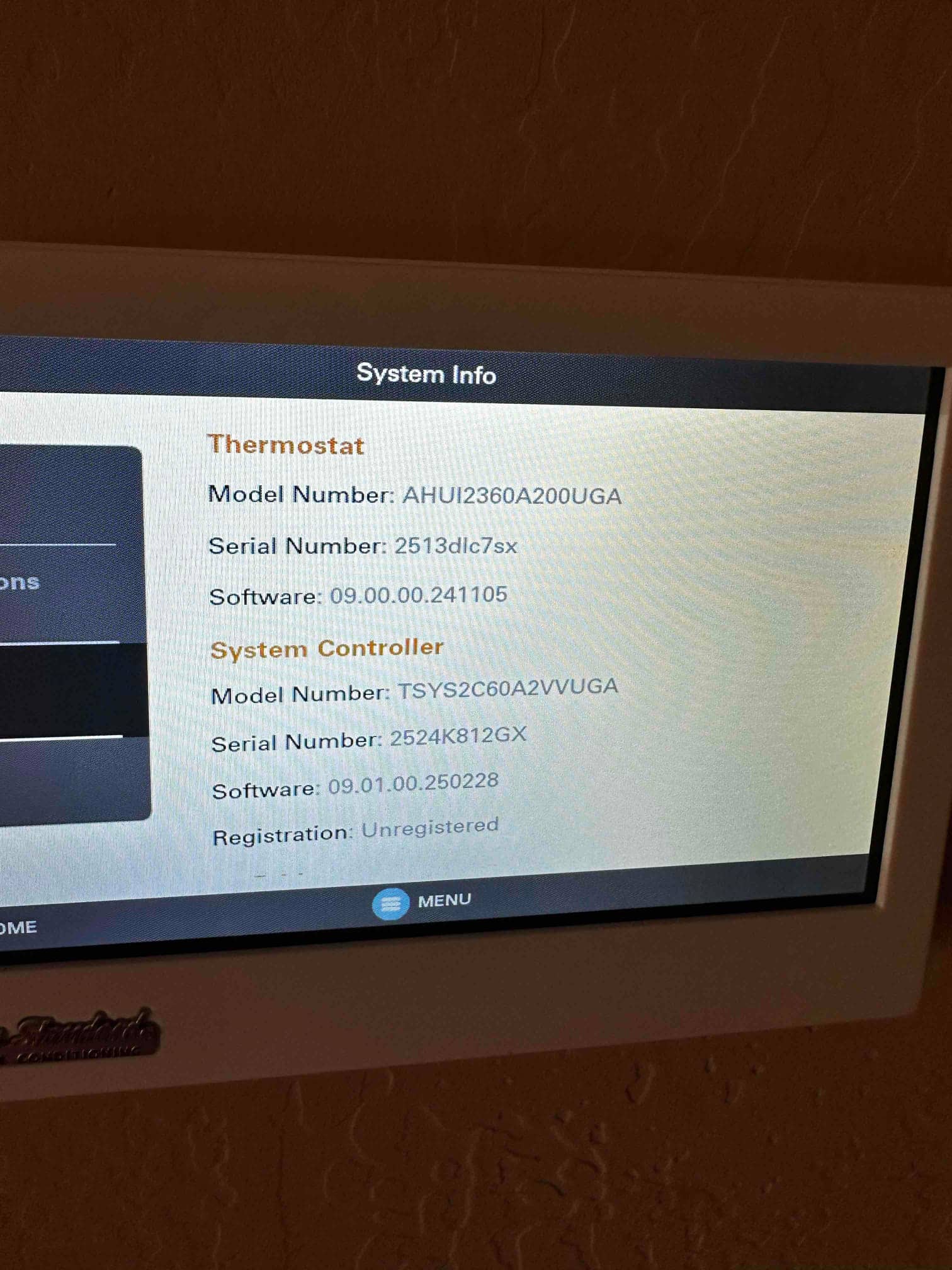 Thermostat touchscreen displays system information and software versions after installation, confirming connectivity and setup at the control interface.