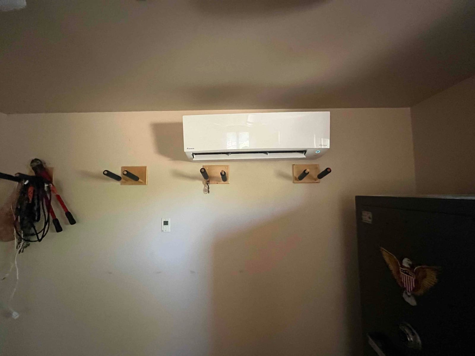 Wall-mounted mini-split indoor unit installed and operating, with line set penetration concealed and a clean, finished appearance.