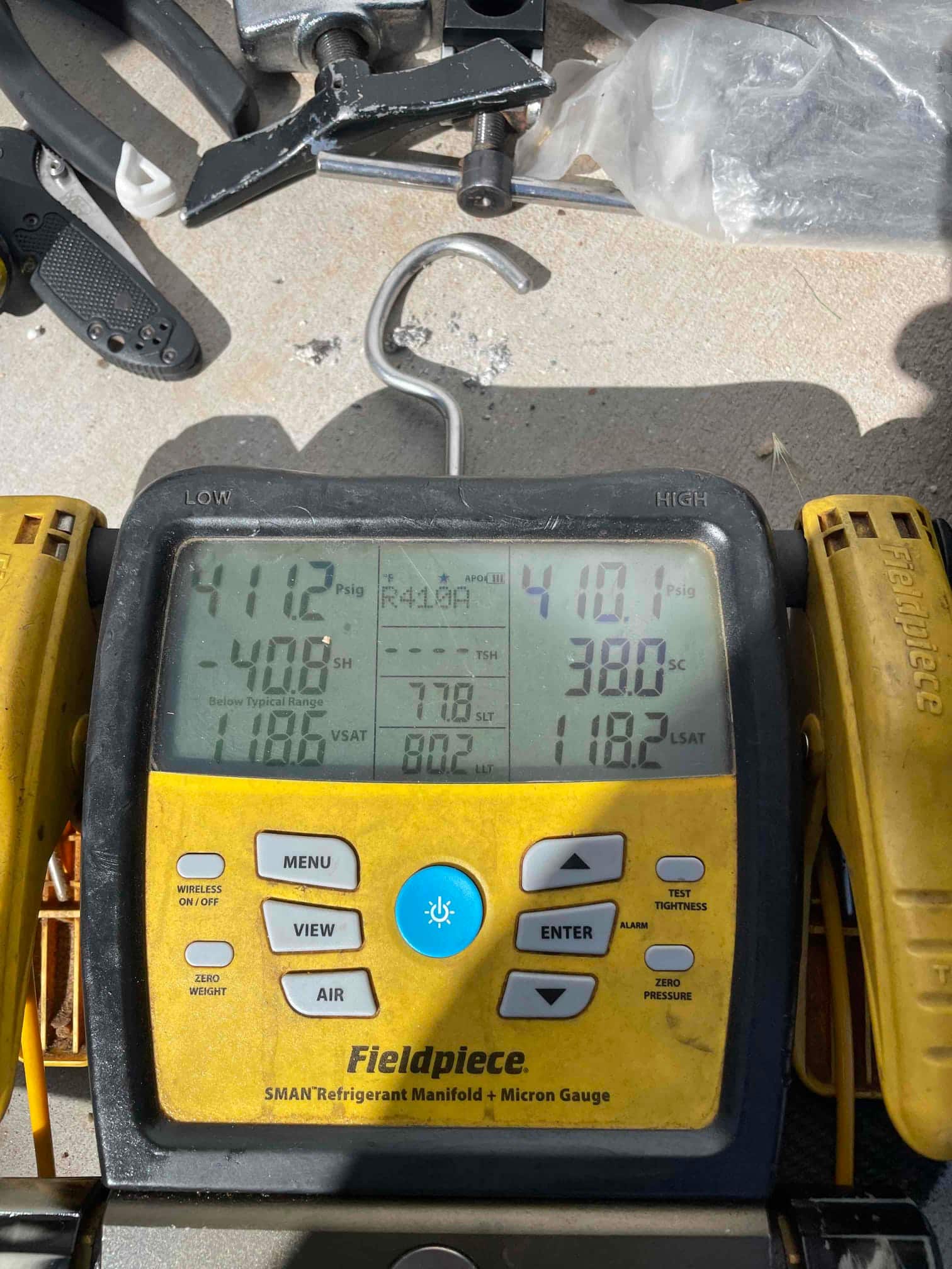 Digital manifold shows equal pressures on both sides at approximately 410 PSI, documenting a nitrogen pressure test on the new installation.