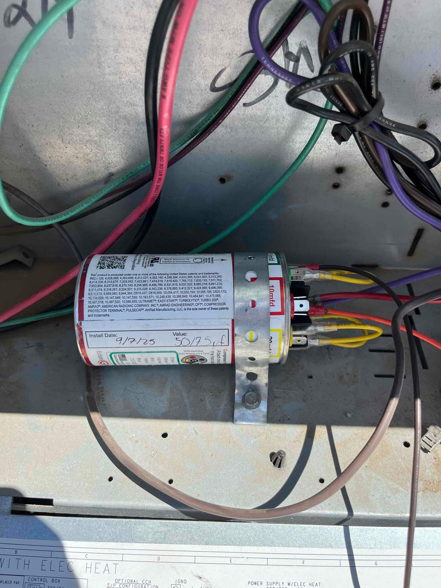 New dual-run capacitor installed with secure strap and connected leads, labeled 50/5 μF with installation date 9/19/25 written on casing.