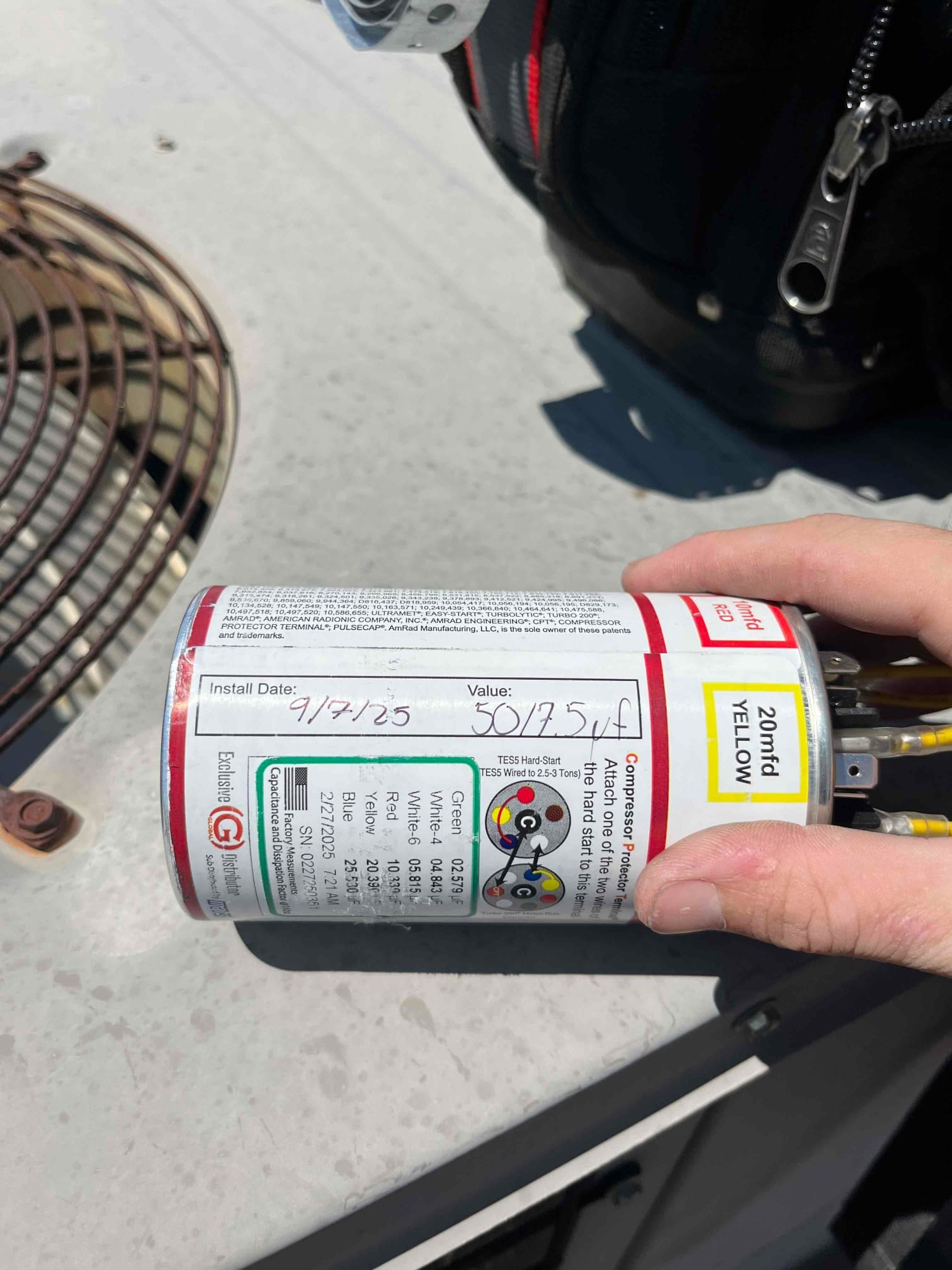 New turbo run capacitor installed on the condenser, wiring connected, with handwritten value noted as 50.25 μF.