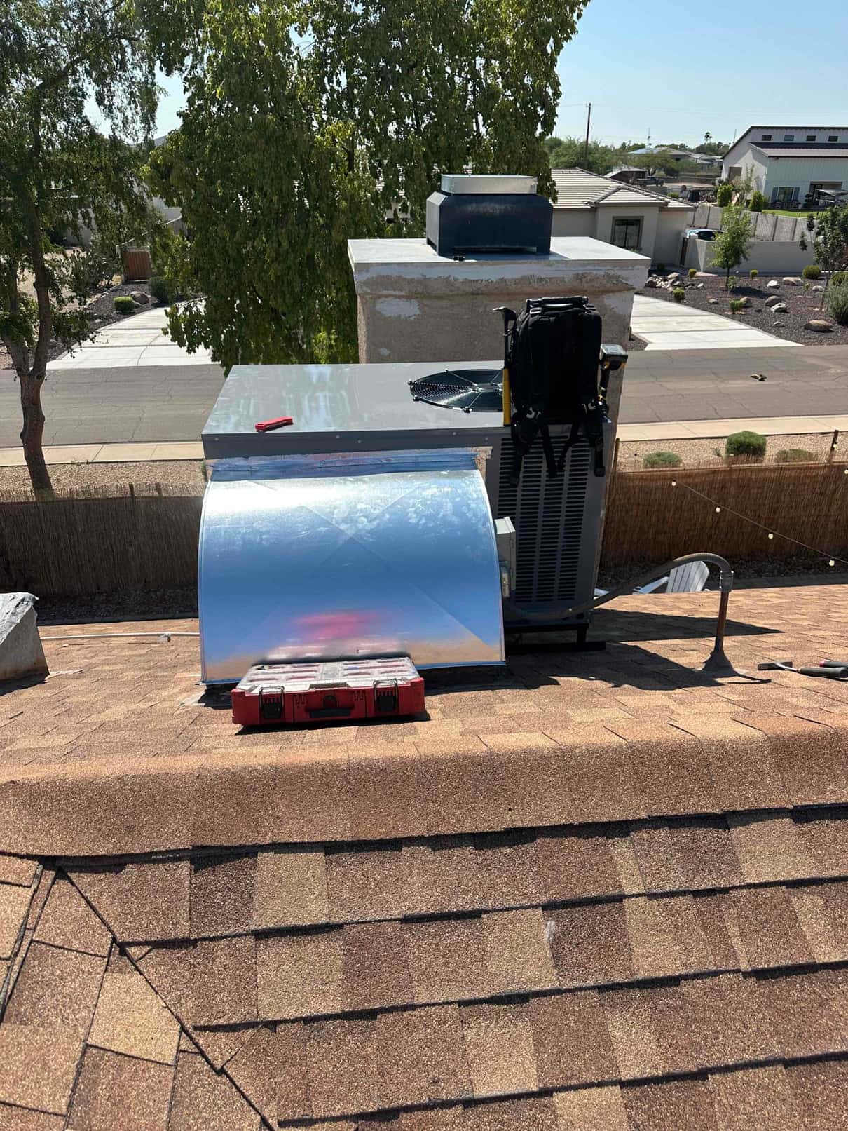 Rooftop package unit set on the roof with new sheet-metal curb adapter and sealed duct connection during installation.