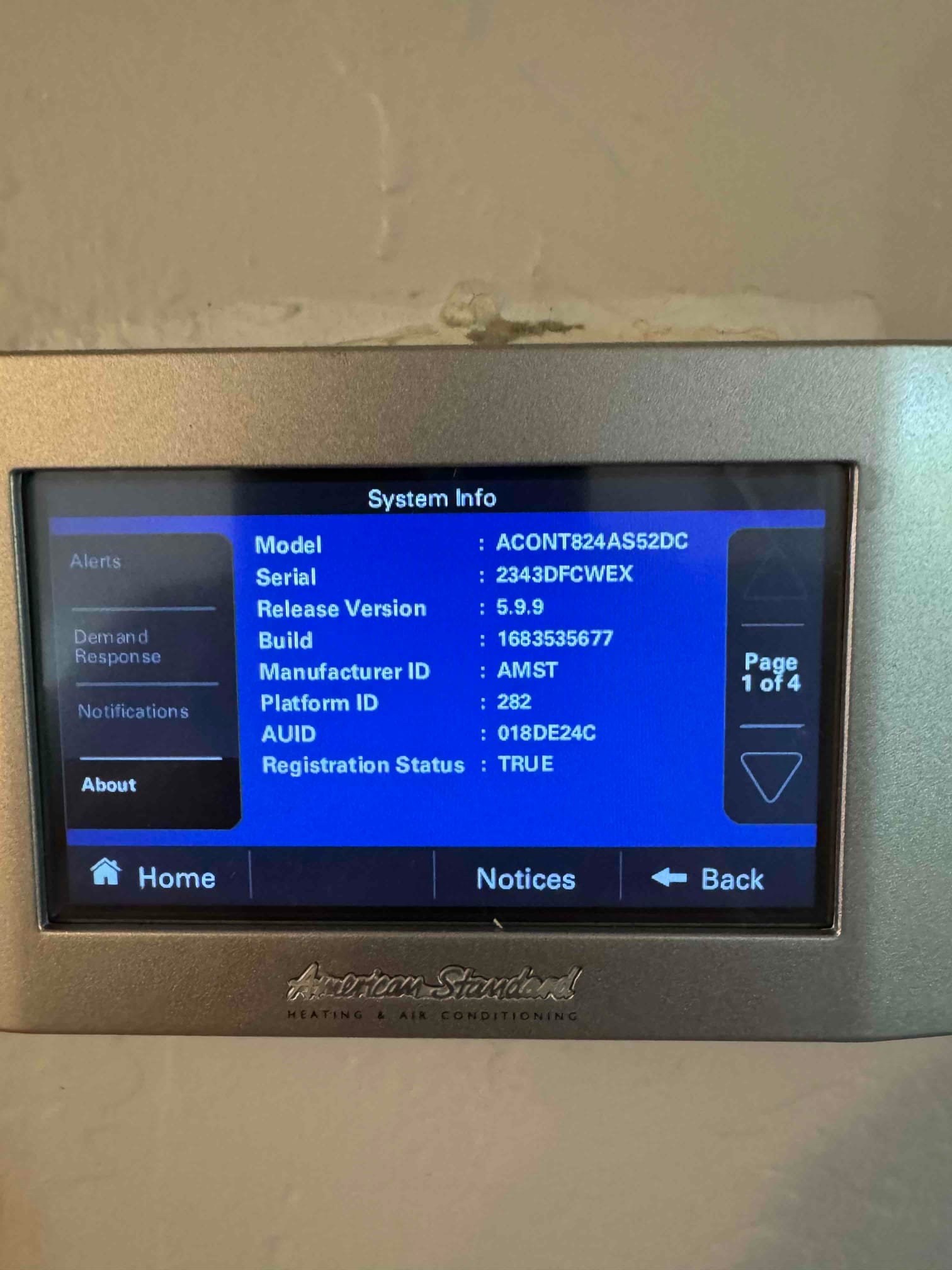 Thermostat system information screen displayed after installation, showing software version and device identifiers on the wall-mounted control.