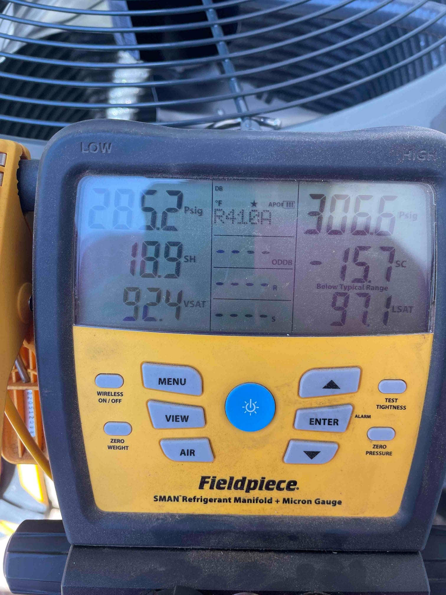 Digital manifold shows system operating with distinct low and high pressures while connected at the outdoor condenser.