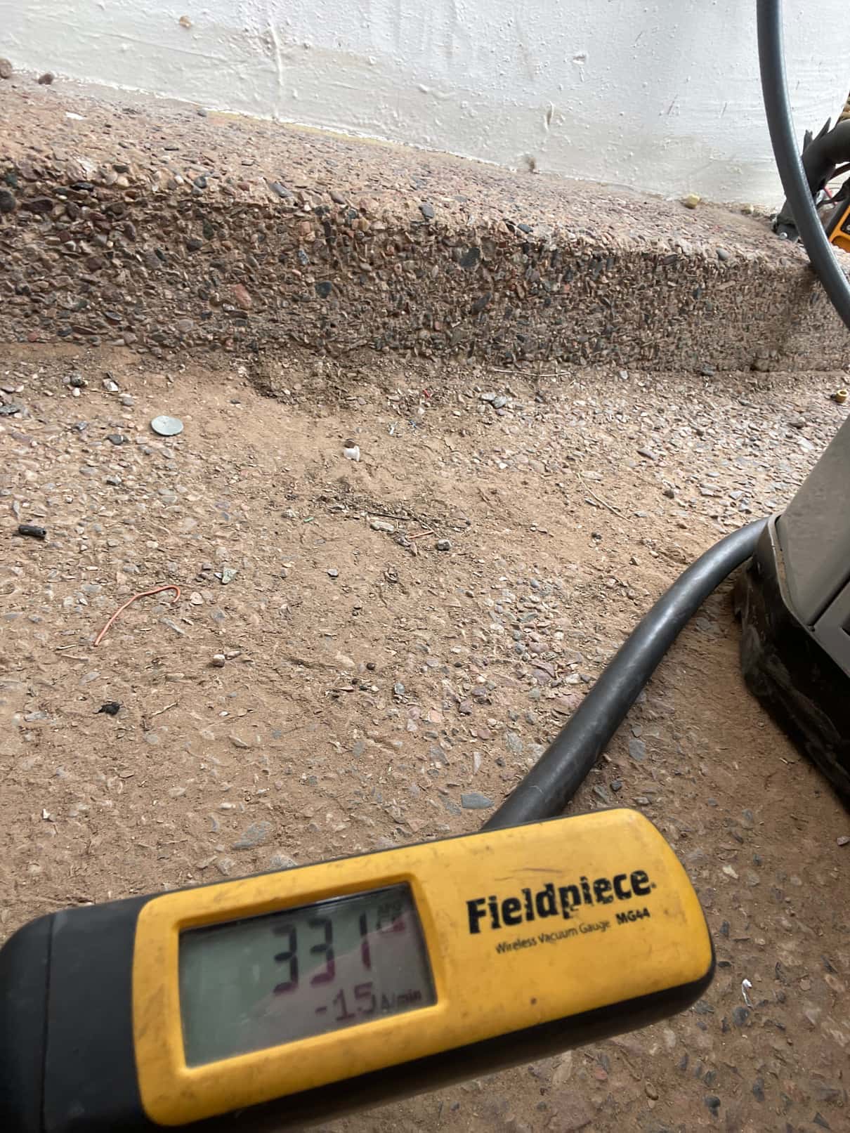 Digital micron gauge shows 337 microns during system evacuation, confirming a deep vacuum prior to refrigerant charging.