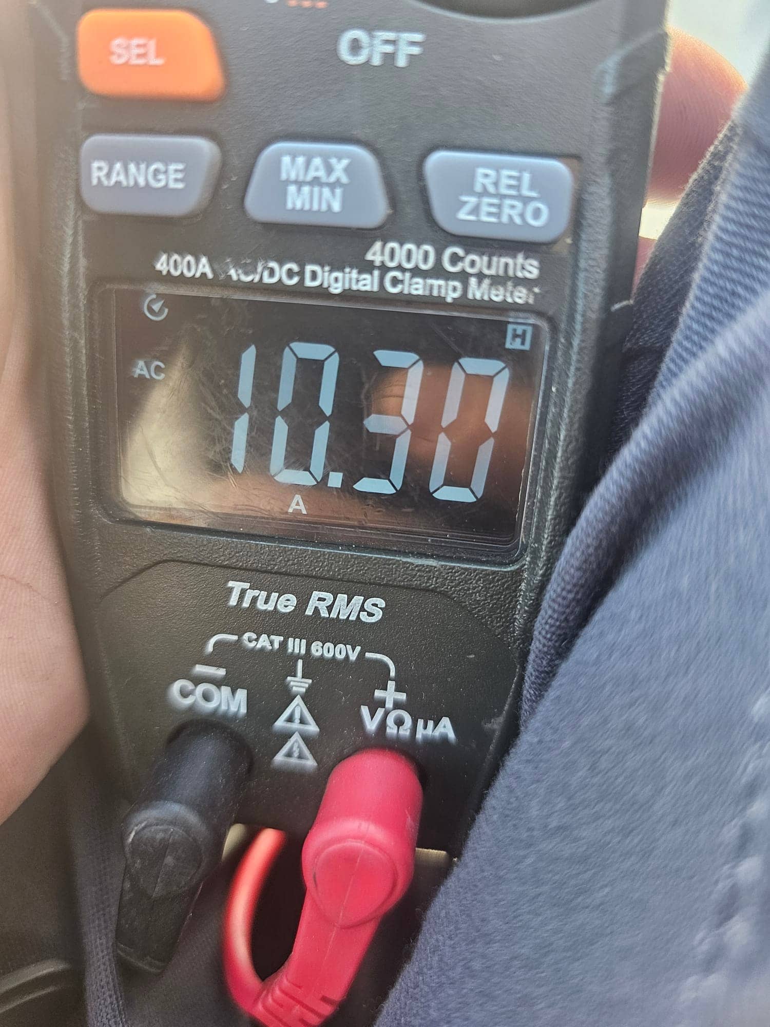Clamp meter display shows 10.30 A AC current with leads connected, documenting live amperage during HVAC system operation.