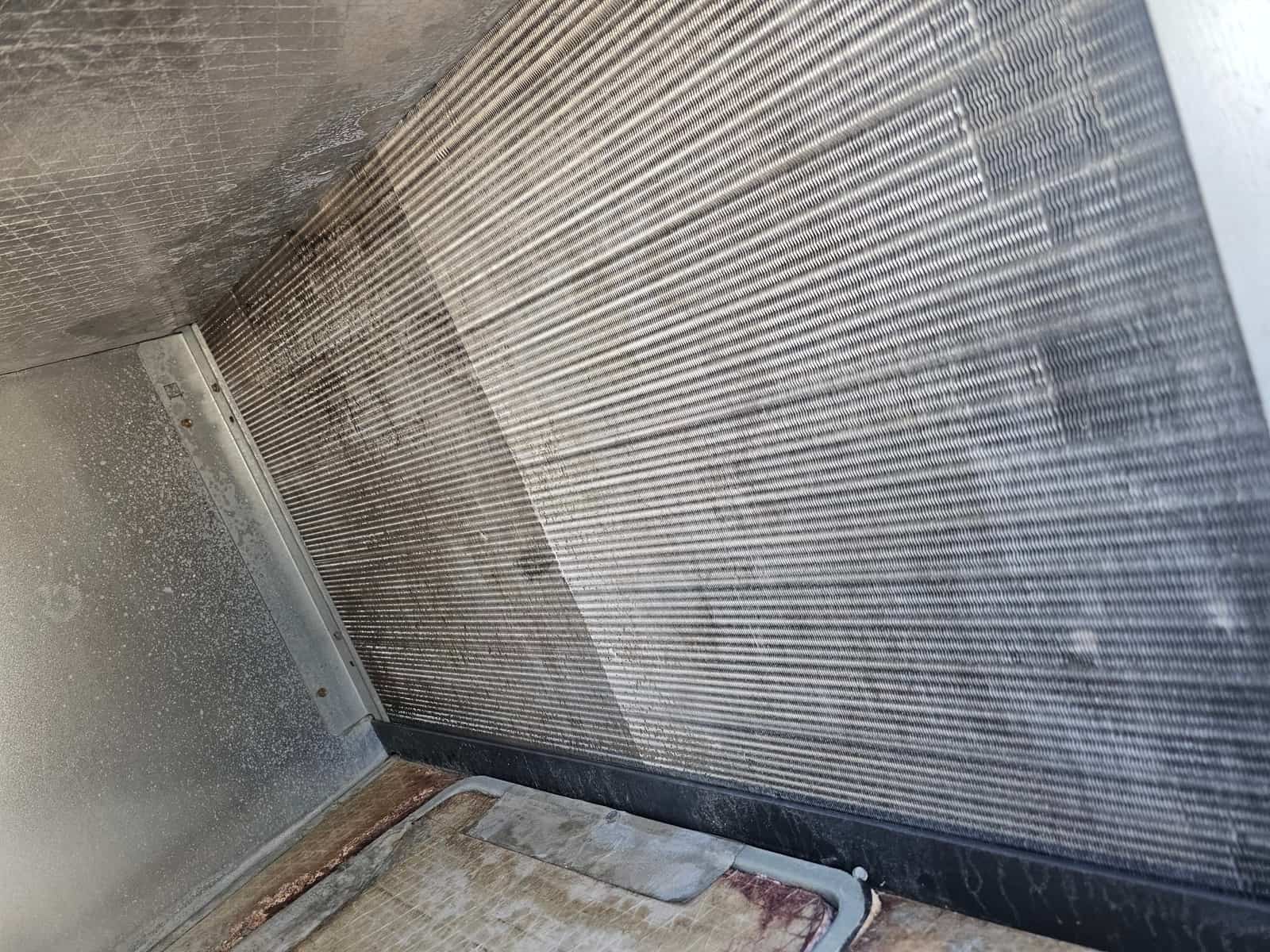 Clean evaporator coil fins inside the air handler, showing clear fin spacing and no visible debris or buildup.