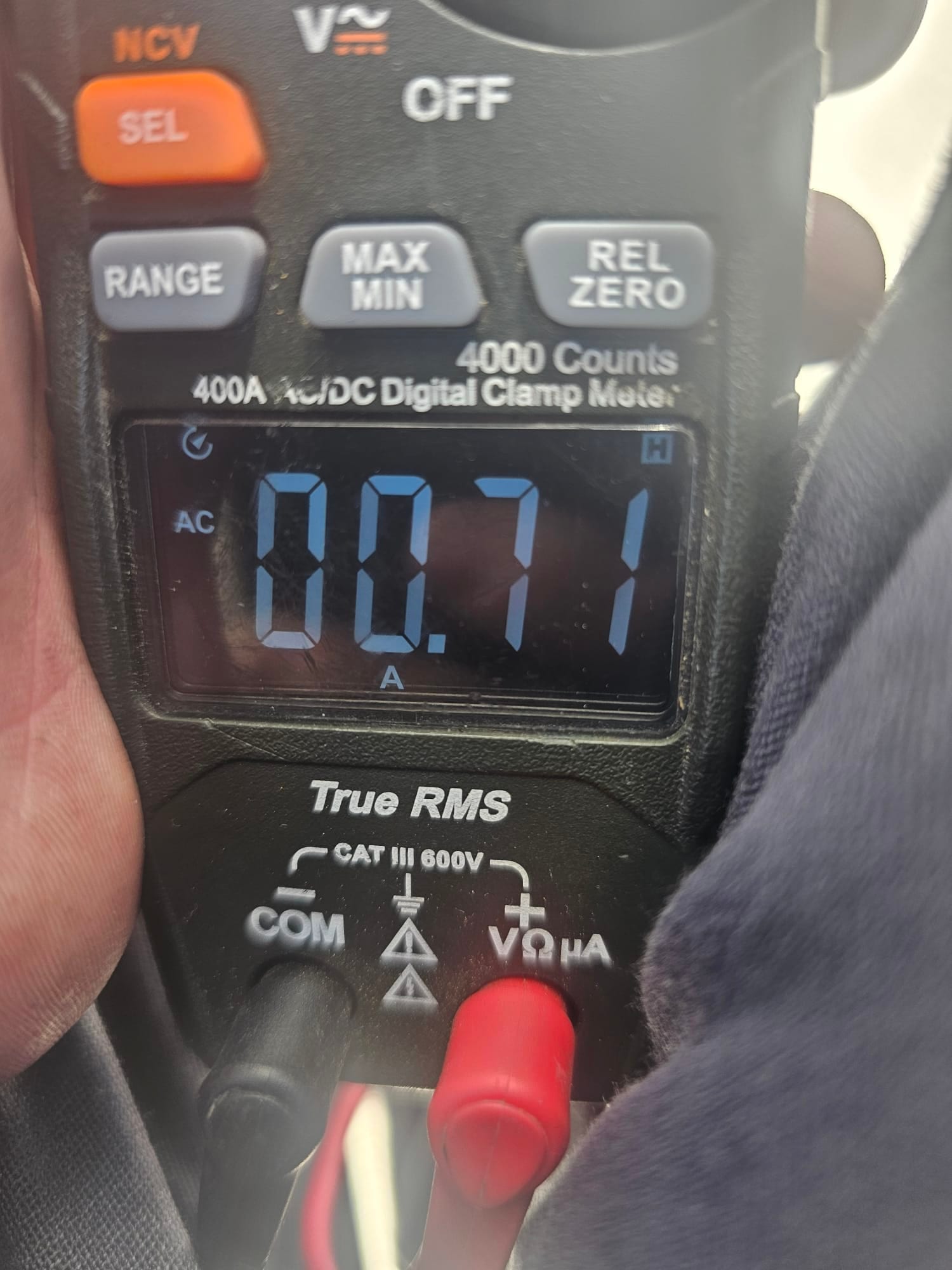 Digital clamp meter displays 0.71 A AC current on the HVAC system during testing.